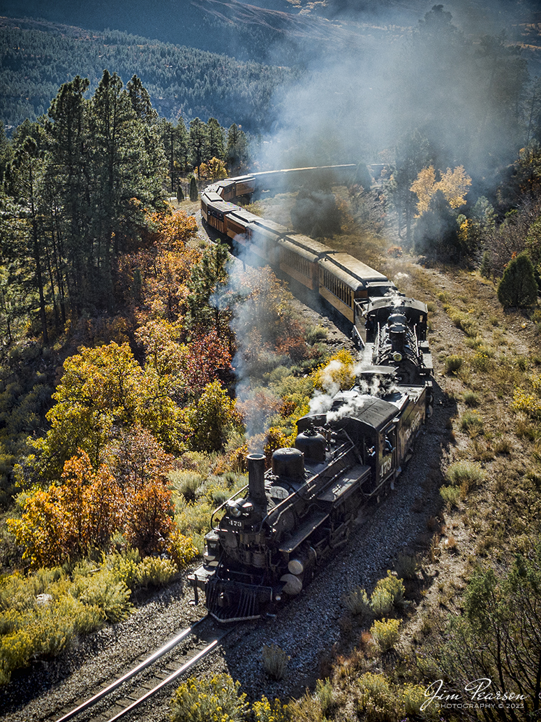 Denver and Rio Grande Western double header steam locomotives 473 and 493 pull a daily passenger train through a S curve as it approaches Hermosa, Colorado on their run between Durango and Silverton, CO, on October 18th, 2023. 

According to Wikipedia: The Durango and Silverton Narrow Gauge Railroad, often abbreviated as the D&SNG, is a 3 ft (914 mm) narrow-gauge heritage railroad that operates on 45.2 mi (72.7 km) of track between Durango and Silverton, in the U.S. state of Colorado. The railway is a federally designated National Historic Landmark and was also designated by the American Society of Civil Engineers as a National Historic Civil Engineering Landmark in 1968.

Tech Info: DJI Mavic 3 Classic Drone, RAW, 22mm, f/2.8, 1/1600, ISO 140.

railroad, railroads train, trains, best photo. sold photo, railway, railway, sold train photos, sold train pictures, steam trains, rail transport, railroad engines, pictures of trains, pictures of railways, best train photograph, best photo, photography of trains, steam, train photography, sold picture, best sold picture, Jim Pearson Photography, Durango and Silverton Narrow Guage Railroad, steam train, DRGWRR, Trains from the air, drone