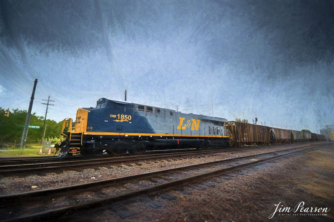 Digital Art Photo - CSX Louisville and Nashville Heritage Unit 1850 leads loaded grain train G031, as it approaches CSX Howell Yard, under stormy skies, at Evansville, Indiana, on October 5th, 2023, on the CSX Evansville Terminal Subdivision. After a crew change and new train ID of G419, the loaded grain train continued its move south to Mobile, Alabama.


According to CSXT: CSX has introduced the sixth locomotive in its heritage series, a freshly painted unit honoring the Louisville & Nashville Railroad. Designated CSX 1850, the locomotive will be placed into service, carrying the L&N colors across the 20,000-mile CSX network.


The paint scheme was designed and applied at the CSX Locomotive Shop in Waycross, Georgia, which has produced all six units in the heritage series celebrating the lines that came together to form the modern CSX. Like the other heritage locomotives, the L&N unit combines the heritage railroad’s iconic logo and colors on the rear two-thirds of the engine with today’s CSX colors and markings on the cab end.


Chartered by the State of Kentucky in 1850, the L&N grew into a vital transportation link between the Gulf Coast and the nation’s heartland. The railroad was absorbed by the Seaboard Coast Line Railroad, which subsequently became part of the Chessie System and, ultimately, today’s CSX.


The CSX heritage series is reinforcing employee pride in the history of the railroad that continues to move the nation’s economy with safe, reliable, and sustainable rail-based transportation services.


Tech Info: DJI Mavic 3 Classic Drone, RAW, 22mm, f/8, 1/1250, ISO 250.


#trainphotography #railroadphotography #trains #railways #jimpearsonphotography #trainphotographer #railroadphotographer #CSXHeritage #EvansvolleIndiana #dronephoto #trainsfromadrone #IndianaTrains #CSXLandNHeritageunit