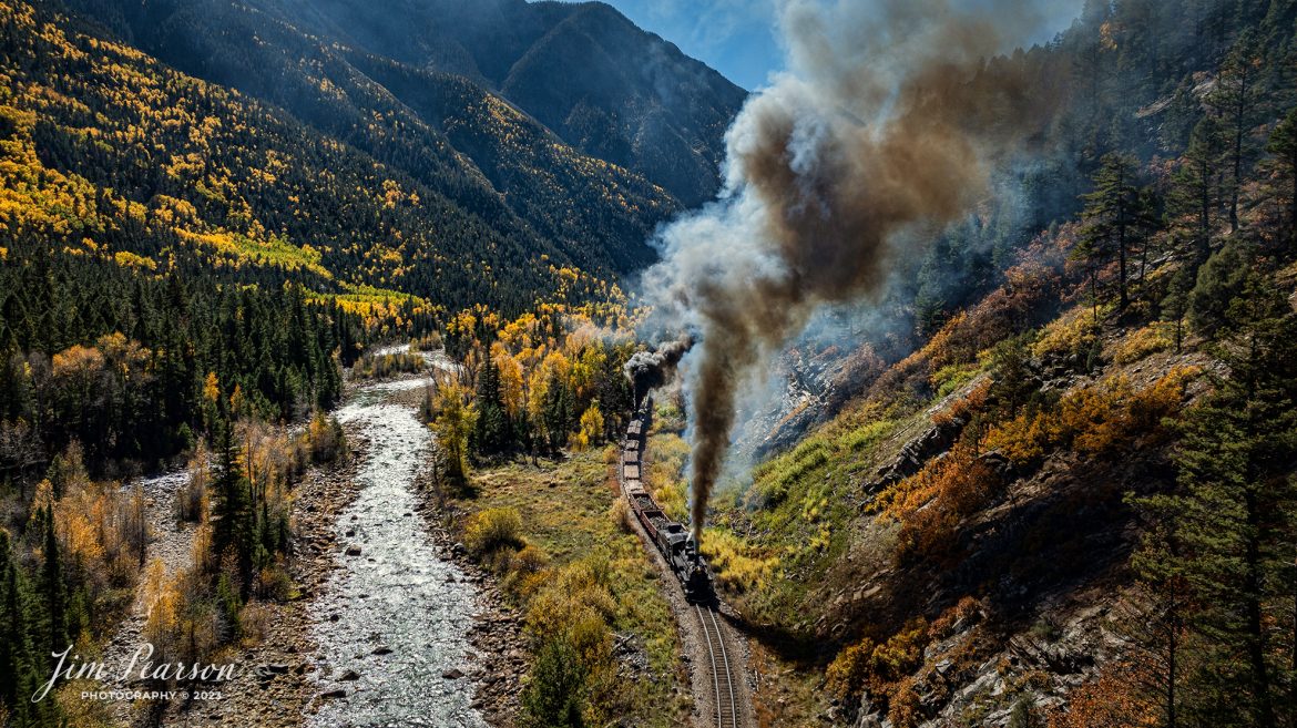 Durango and Silverton Narrow Gauge steam locomotive D&RGW 473 leads a K-28 100th Anniversary Special with D&RGW 476 as a mid-train helper as they head south through Deadwood Gulch, approaching Silverton, Colorado on October 16th, 2023.


According to Wikipedia: The Durango and Silverton Narrow Gauge Railroad, often abbreviated as the D&SNG, is a 3 ft (914 mm) narrow-gauge heritage railroad that operates on 45.2 mi (72.7 km) of track between Durango and Silverton, in the U.S. state of Colorado. The railway is a federally designated National Historic Landmark and was also designated by the American Society of Civil Engineers as a National Historic Civil Engineering Landmark in 1968.

Tech Info: DJI Mavic 3 Classic Drone, RAW, 22mm, f/2.8, 1/2000, ISO 170.

#railroad #railroads #train, #trains #bestphoto #soldphoto #railway #railway #soldtrainphotos #steamtrains #railtransport #railroadengines #picturesoftrains #picturesofrailways #besttrainphotograph #bestphoto #photographyoftrains #steamtrainphotography #soldpicture #bestsoldpicture #JimPearsonPhotography #DurangoandSilvertonRailroad
