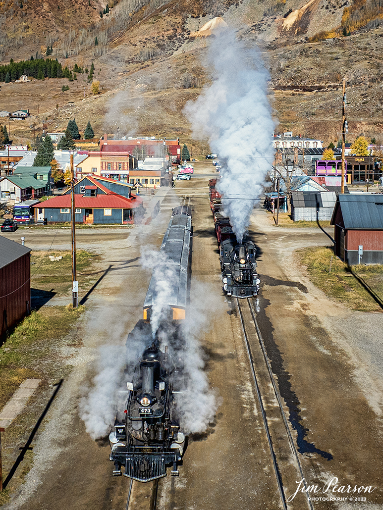 Durango and Silverton Narrow Gauge steam locomotive D&RGW 473 and 476 sit at Silverton, Colorado in the early morning of October 17th, 2023. They were running on the line as a K-28 100th Anniversary Special between Silverton and Durango, Colorado and here the crews are getting their trains ready for another day of running the photo charter special.

According to Wikipedia: The Durango and Silverton Narrow Gauge Railroad, often abbreviated as the D&SNG, is a 3 ft (914 mm) narrow-gauge heritage railroad that operates on 45.2 mi (72.7 km) of track between Durango and Silverton, in the U.S. state of Colorado. The railway is a federally designated National Historic Landmark and was also designated by the American Society of Civil Engineers as a National Historic Civil Engineering Landmark in 1968.

Tech Info: DJI Mavic 3 Classic Drone, RAW, 22mm, f/2.8, 1/3200, ISO 160.

#railroad #railroads #train, #trains #bestphoto #soldphoto #railway #railway #soldtrainphotos #steamtrains #railtransport #railroadengines #picturesoftrains #picturesofrailways #besttrainphotograph #bestphoto #photographyoftrains #steamtrainphotography #soldpicture #bestsoldpicture #JimPearsonPhotography #DurangoandSilvertonRailroad