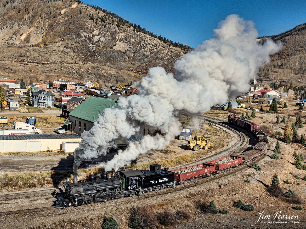 Denver and Rio Grande Western 476 departs Silverton, Colorado, on October 17th, 2023, as they head back toward Durango with a freight train, as part of their annual photography charter. 

According to Wikipedia: The Durango and Silverton Narrow Gauge Railroad, often abbreviated as the D&SNG, is a 3 ft (914 mm) narrow-gauge heritage railroad that operates on 45.2 mi (72.7 km) of track between Durango and Silverton, in the U.S. state of Colorado. The railway is a federally designated National Historic Landmark and was also designated by the American Society of Civil Engineers as a National Historic Civil Engineering Landmark in 1968.

Tech Info: DJI Mavic 3 Classic Drone, RAW, 22mm, f/2.8, 1/2000, ISO 120.

#railroad #railroads #train, #trains #bestphoto #soldphoto #railway #railway #soldtrainphotos #steamtrains #railtransport #railroadengines #picturesoftrains #picturesofrailways #besttrainphotograph #bestphoto #photographyoftrains #steamtrainphotography #soldpicture #bestsoldpicture #JimPearsonPhotography #DurangoandSilvertonRailroad
