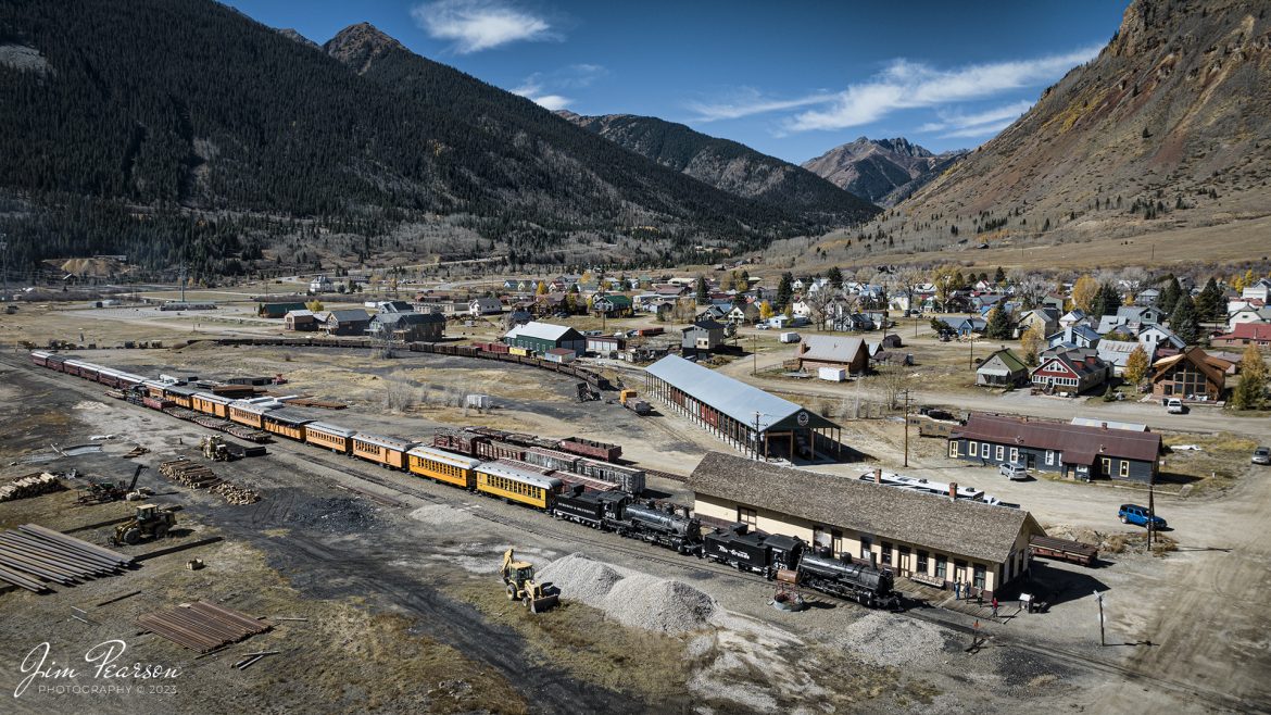 Denver and Rio Grande Western double header steam locomotives 473 and 493 pass the depot at Silverton, CO, on October 18th, 2023, as they head into downtown to drop off their passengers. 

According to Wikipedia: The Durango and Silverton Narrow Gauge Railroad, often abbreviated as the D&SNG, is a 3 ft (914 mm) narrow-gauge heritage railroad that operates on 45.2 mi (72.7 km) of track between Durango and Silverton, in the U.S. state of Colorado. The railway is a federally designated National Historic Landmark and was also designated by the American Society of Civil Engineers as a National Historic Civil Engineering Landmark in 1968.

Tech Info: DJI Mavic 3 Classic Drone, RAW, 22mm, f/2.8, 1/1250, ISO 100.

#railroad #railroads #train, #trains #bestphoto #soldphoto #railway #railway #soldtrainphotos #steamtrains #railtransport #railroadengines #picturesoftrains #picturesofrailways #besttrainphotograph #bestphoto #photographyoftrains #steamtrainphotography #soldpicture #bestsoldpicture #JimPearsonPhotography #DurangoandSilvertonRailroad