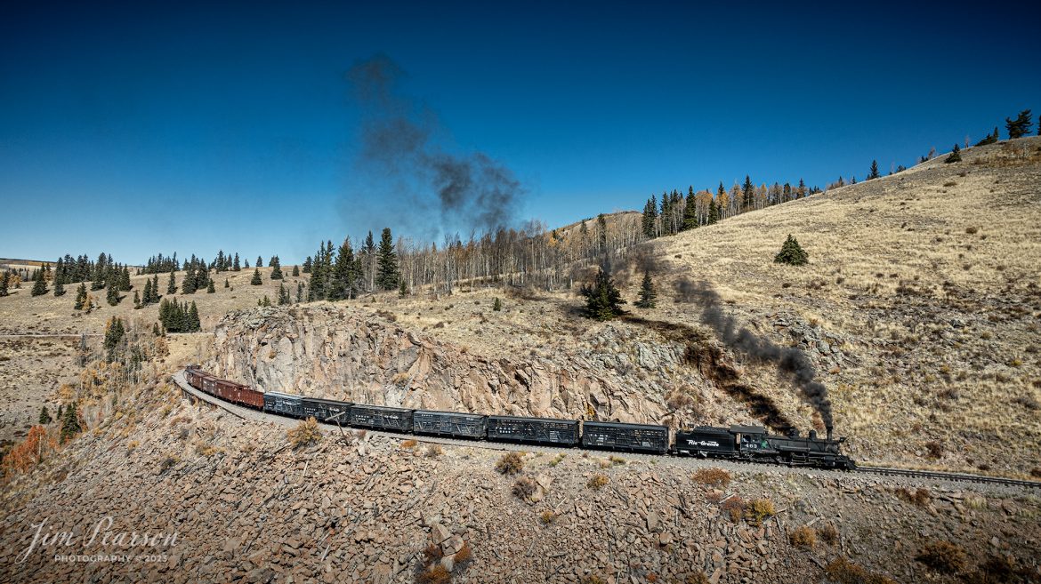 Cumbres & Toltec Scenic Railroad steam locomotive D&RGW 463 makes its way through the countryside with a freight train on the way to Osier, Colorado, during a photo charter by Dak Dillon Photography on October 19th, 2023.

According to their website: the Cumbres & Toltec Scenic Railroad is a National Historic Landmark.  At 64-miles in length, it is the longest, the highest and most authentic steam railroad in North America, traveling through some of the most spectacular scenery in the Rocky Mountain West.

Owned by the states of Colorado and New Mexico, the train crosses state borders 11 times, zigzagging along canyon walls, burrowing through two tunnels, and steaming over 137-foot Cascade Trestle. All trains steam along through deep forests of aspens and evergreens, across high plains filled with wildflowers, and through a rocky gorge of remarkable geologic formations. Deer, antelope, elk, fox, eagles and even bear are frequently spotted on this family friendly, off-the grid adventure.

According to History Colorado Website: Built in 1903 by the Baldwin Locomotive Works of Philadelphia, Engine No. 463 is one of only two remaining locomotives of the K-27 series originally built for and operated by the Denver & Rio Grande Western Railroad.

The K-27 series was a departure from the design most prevalent on Colorado’s narrow-gauge lines, resulting in a locomotive with one and one-half times more power.  The arrival of this series marked a significant turning point in the operation of the D&RGW’s narrow gauge lines that was to remain in effect until the end of Class I narrow gauge steam locomotion in 1968.  The Friends of the Cumbres & Toltec Scenic Railroad restored the engine to operating condition.

Tech Info: DJI Mavic 3 Classic Drone, RAW, 22mm, f/2.8, 1/1600, ISO 100.

railroad, railroads train, trains, best photo. sold photo, railway, railway, sold train photos, sold train pictures, steam trains, rail transport, railroad engines, pictures of trains, pictures of railways, best train photograph, best photo, photography of trains, steam, train photography, sold picture, best sold picture, Jim Pearson Photography, Cumbres & Toltec Scenic Railroad, steam train, CTSRR, Trains from the air, drone