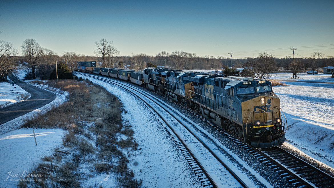 CSXT 906 heads up a trio of power on hot intermodal I026 heads north on a freezing cold day as it approaches the north end of the siding at Kelly, Kentucky, on January 16th, 2024, on the Henderson Subdivision.

Tech Info: DJI Mavic 3 Classic Drone, RAW, 22mm, f/2.8, 1/2000, ISO 200.

#trainphotography #railroadphotography #trains #railways #jimpearsonphotography #trainphotographer #railroadphotographer #csxt #dronephoto #trainsfromadrone #csxhendersonsubdivision #trending