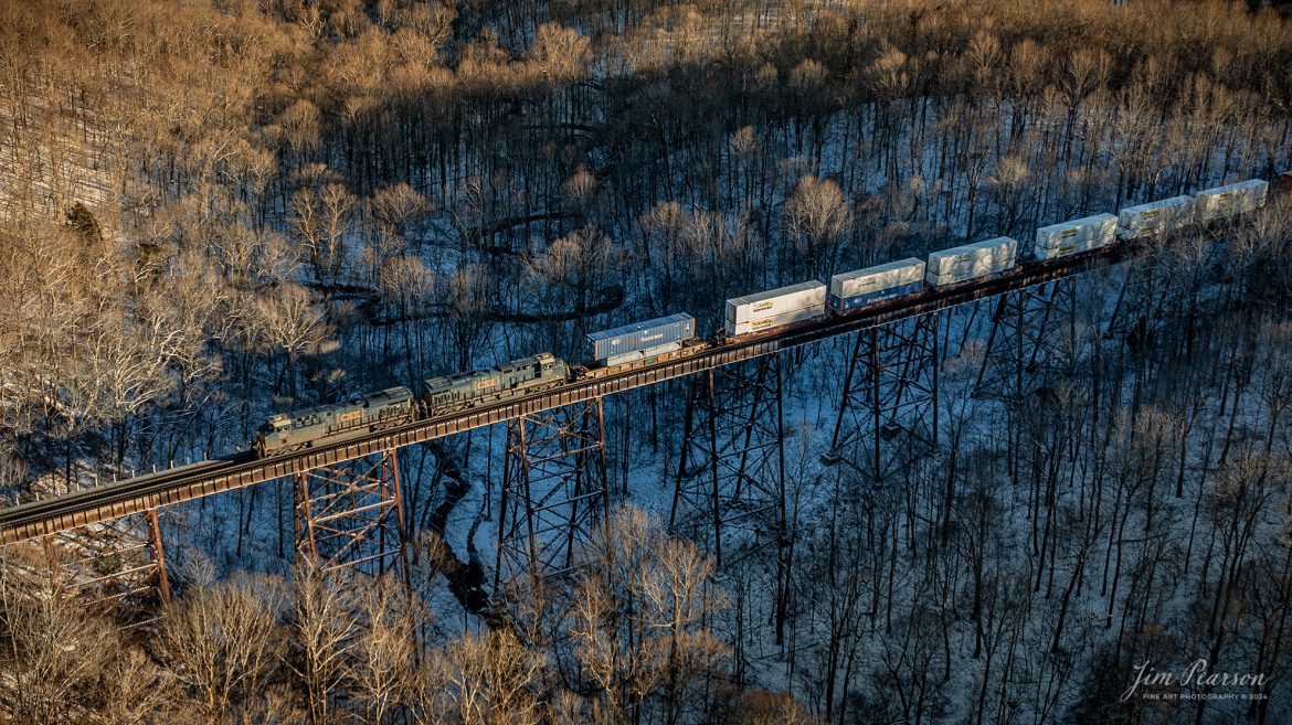 CSXT 3031 and 3008 lead CSX I128 lead their loaded intermodal north across Gum Lick Trestle, just outside of Kelly, Kentucky, as they make their way north through the frigid countryside, on January 16th, 2024, on the Henderson Subdivision.

Gum Lick trestle is located between Kelly and Crofton, Ky and not only the longest trestle on the subdivision but also the highest on the old Louisville and Nashville Railway line, now known as the Henderson Subdivision.

Tech Info: DJI Mavic 3 Classic Drone, RAW, 22mm, f/2.8, 1/400, ISO 110.

#trainphotography #railroadphotography #trains #railways #jimpearsonphotography #trainphotographer #railroadphotographer #csxt #dronephoto #trainsfromadrone #csxhendersonsubdivision #trending
