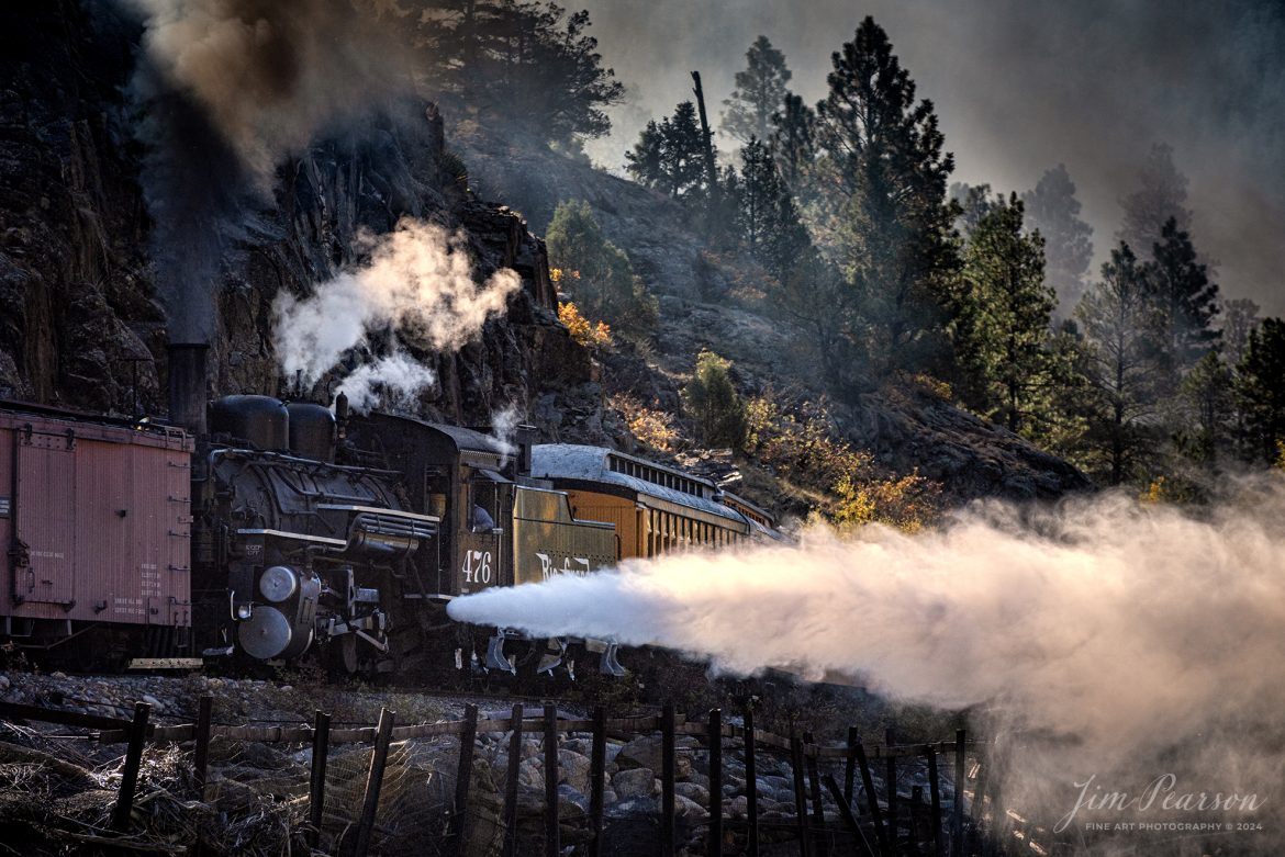 Durango and Silverton Narrow Gauge steam locomotive D&RGW 476 runs as a mid-train helper on a K-28 100th Anniversary Special as they head through the Repeating Curves at MP 472.2, along the Animas River, between Durango and Silverton, Colorado, on October 16th, 2023.

According to Wikipedia: The Durango and Silverton Narrow Gauge Railroad, often abbreviated as the D&SNG, is a 3 ft (914 mm) narrow-gauge heritage railroad that operates on 45.2 mi (72.7 km) of track between Durango and Silverton, in the U.S. state of Colorado. The railway is a federally designated National Historic Landmark and was also designated by the American Society of Civil Engineers as a National Historic Civil Engineering Landmark in 1968.

Tech Info: DJI Mavic 3 Classic Drone, RAW, 22mm, f/2.8, 1/1000, ISO 110.

#railroad #railroads #train, #trains #bestphoto #soldphoto #railway #railway #soldtrainphotos #steamtrains #railtransport #railroadengines #picturesoftrains #picturesofrailways #besttrainphotograph #bestphoto #photographyoftrains #steamtrainphotography #soldpicture #bestsoldpicture #JimPearsonPhotography #DurangoandSilvertonRailroad