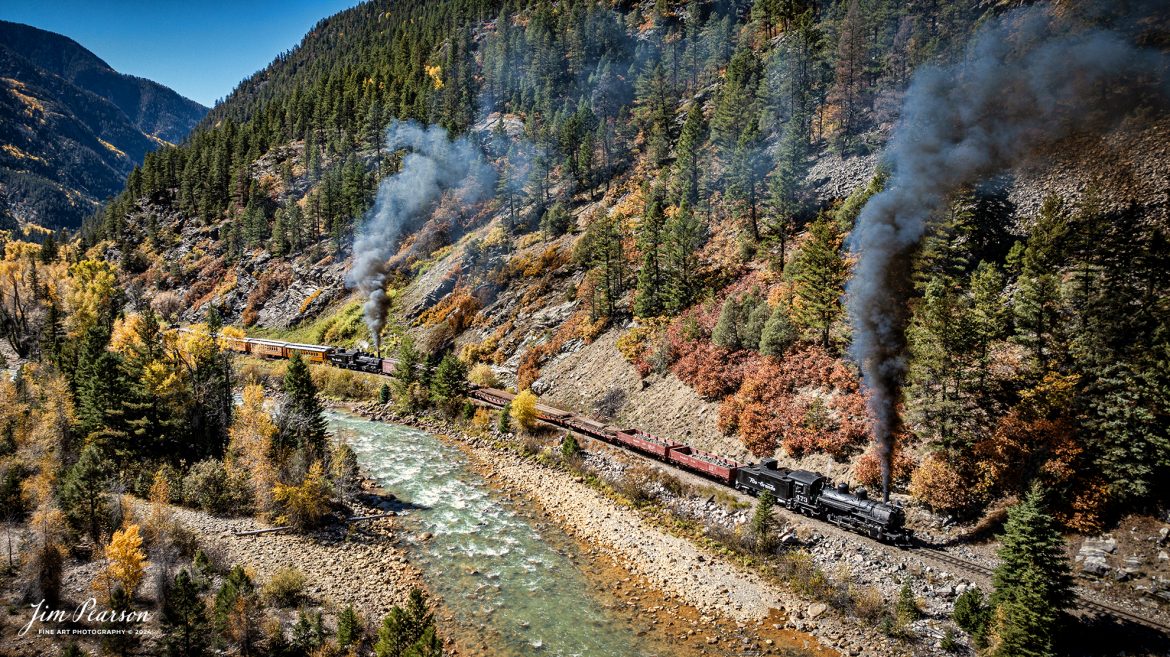 Durango and Silverton Narrow Gauge steam locomotive D&RGW 473 leads a K-28 100th Anniversary Special with D&RGW 476 as a mid-train helper as they head south through Deadwood Gulch, approaching Silverton, Colorado on October 16th, 2023.


According to Wikipedia: The Durango and Silverton Narrow Gauge Railroad, often abbreviated as the D&SNG, is a 3 ft (914 mm) narrow-gauge heritage railroad that operates on 45.2 mi (72.7 km) of track between Durango and Silverton, in the U.S. state of Colorado. The railway is a federally designated National Historic Landmark and was also designated by the American Society of Civil Engineers as a National Historic Civil Engineering Landmark in 1968.

Tech Info: DJI Mavic 3 Classic Drone, RAW, 22mm, f/2.8, 1/1000, ISO 120.

#railroad #railroads #train, #trains #bestphoto #soldphoto #railway #railway #soldtrainphotos #steamtrains #railtransport #railroadengines #picturesoftrains #picturesofrailways #besttrainphotograph #bestphoto #photographyoftrains #steamtrainphotography #soldpicture #bestsoldpicture #JimPearsonPhotography #DurangoandSilvertonRailroad