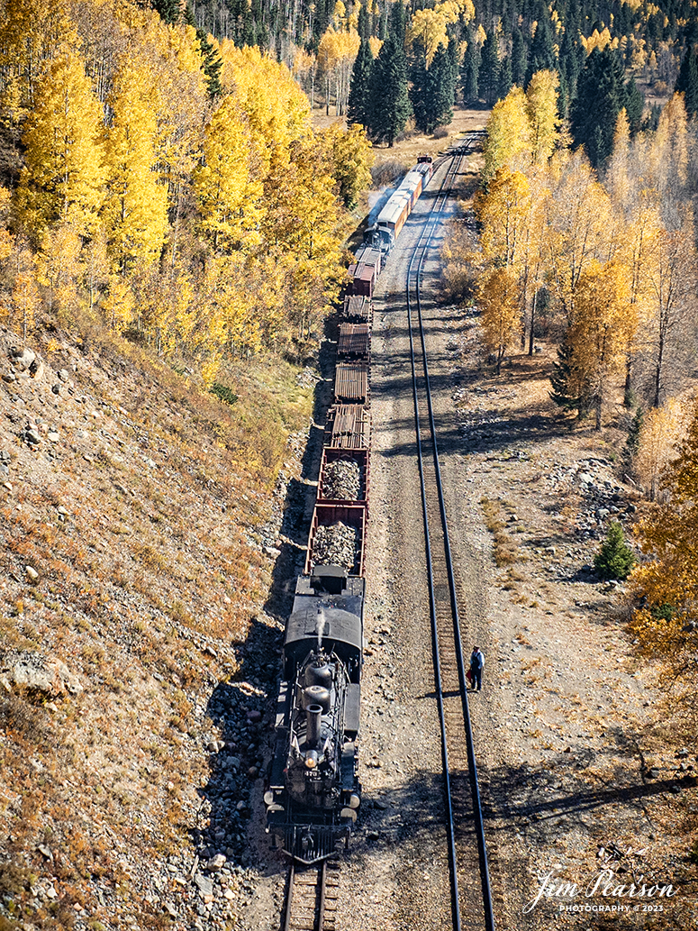 Durango and Silverton Narrow Gauge steam locomotive D&RGW 473 with mid-train helper D&RGW 476 on a K-28 100th Anniversary Special, sit in the siding at Elk Park as they and their conductor wait to meet a passenger train from Silverton, Colorado, on October 16th, 2023.

According to Wikipedia: The Durango and Silverton Narrow Gauge Railroad, often abbreviated as the D&SNG, is a 3 ft (914 mm) narrow-gauge heritage railroad that operates on 45.2 mi (72.7 km) of track between Durango and Silverton, in the U.S. state of Colorado. The railway is a federally designated National Historic Landmark and was also designated by the American Society of Civil Engineers as a National Historic Civil Engineering Landmark in 1968.

Tech Info: DJI Mavic 3 Classic Drone, RAW, 22mm, f/2.8, 1/1000, ISO 100.

#railroad #railroads #train, #trains #bestphoto #soldphoto #railway #railway #soldtrainphotos #steamtrains #railtransport #railroadengines #picturesoftrains #picturesofrailways #besttrainphotograph #bestphoto #photographyoftrains #steamtrainphotography #soldpicture #bestsoldpicture #JimPearsonPhotography #DurangoandSilvertonRailroad
