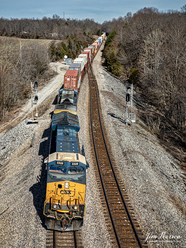 CSXT 3326 leads I025, one of the daily hot intermodals on the CSX Henderson Subdivision, as it splits the signals at the north end of Kelly, Kentucky, on February 1st, 2024, as it heads south to Jacksonville, Florida.

Tech Info: DJI Mavic 3 Classic Drone, RAW, 22mm, f/2.8, 1/1250, ISO 100.

#trainphotography #railroadphotography #trains #railways #jimpearsonphotography #trainphotographer #railroadphotographer #csxt #dronephoto #trainsfromadrone #CSXHendersonsubdivision #trending