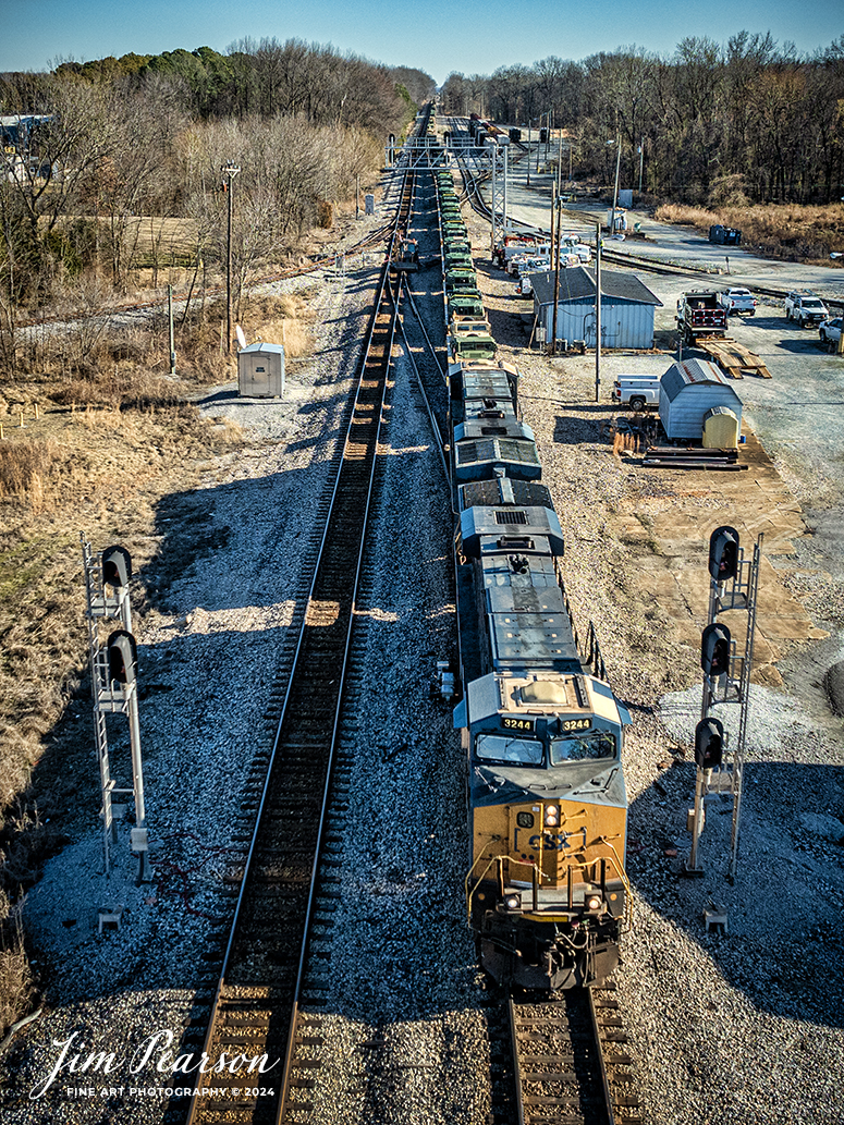 CSX 3244 leads loaded military train, S279, as they pass the signals at the north end of the yard in Guthrie, Kentucky, on October 5th, 2024, on the Henderson Subdivision, bound for Ft. Campbell, Ky. 

Tech Info: DJI Mavic 3 Classic Drone, RAW, 22mm, f/8, 1/2000, ISO 160.

#trainphotography #railroadphotography #trains #railways #jimpearsonphotography #trainphotographer #railroadphotographer #dronephoto #trainsfromadrone #CSX #trending
