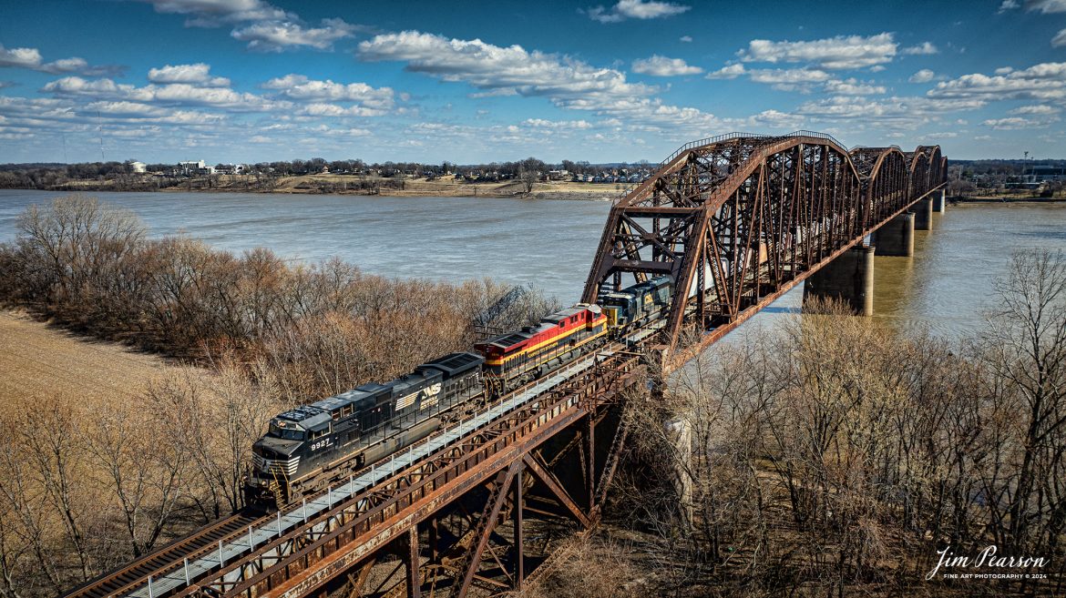 NS 9927, CPKC 4614, and CSXT 4072 lead a northbound loaded Phosphate train across the Ohio River from Henderson, Ky on February 15th, 2024, as it heads north on the Henderson Subdivision.

Tech Info: DJI Mavic 3 Classic Drone, RAW, 22mm, f/2.8, 1/2000, ISO 120.

#trainphotography #railroadphotography #trains #railways #jimpearsonphotography #trainphotographer #railroadphotographer #csxt #dronephoto #trainsfromadrone #CSXHendersonsubdivision #trending