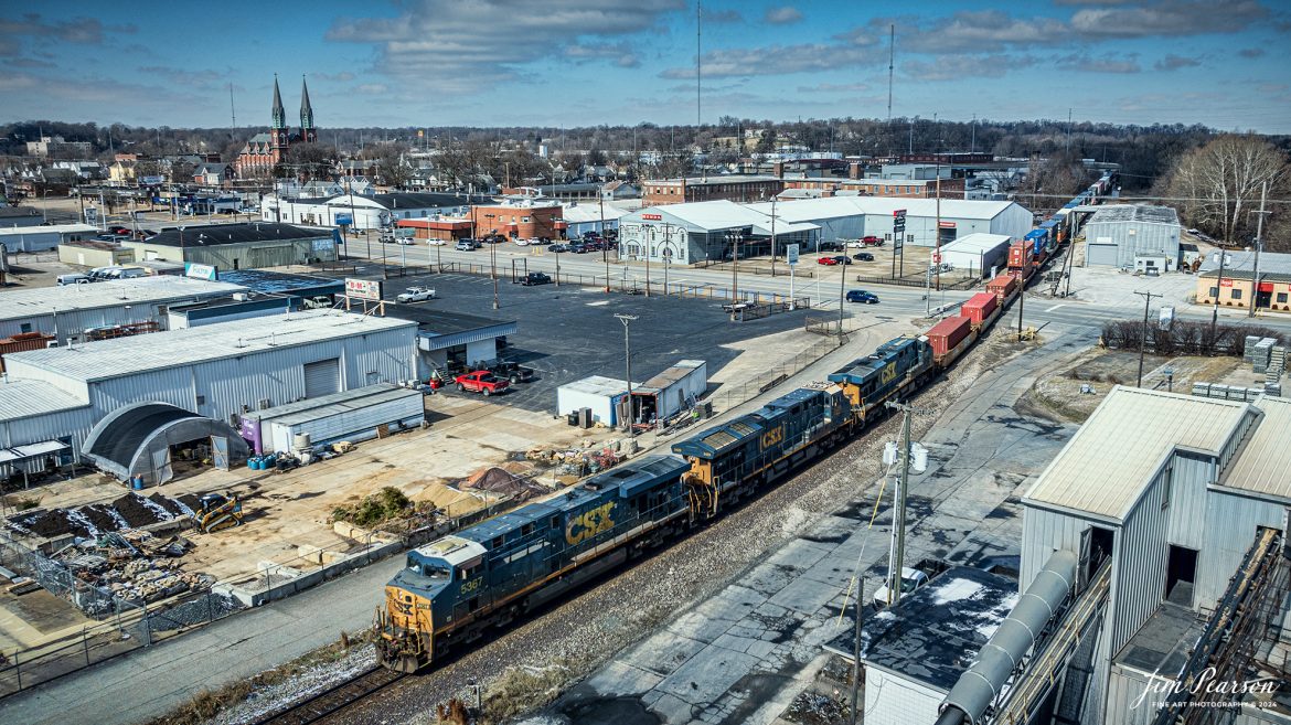 CSX I025 passes over Franklin Street, with the steeples from St Boniface Catholic Church in the background as they head south into Howell Yard at Evansville, Indiana on February 17th, 2024. 

Tech Info: DJI Mavic 3 Classic Drone, RAW, 22mm, f/2.8, 1/3200, ISO 100.

#trainphotography #railroadphotography #trains #railways #jimpearsonphotography #trainphotographer #railroadphotographer #csxt #dronephoto #trainsfromadrone #trending