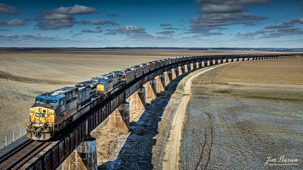 CSX 519 heads up a loaded coal train C319 as it heads south up the viaduct at Rahm, Indiana on February 17th, 2024, toward the Ohio River at Henderson, Kentucky on the Henderson Subdivision after an overnight dusting of snow.

Tech Info: DJI Mavic 3 Classic Drone, RAW, 22mm, f/2.8, 1/2500, ISO 100.

#trainphotography #railroadphotography #trains #railways #jimpearsonphotography #trainphotographer #railroadphotographer #csxt #dronephoto #trainsfromadrone #CSXHendersonsubdivision #trending