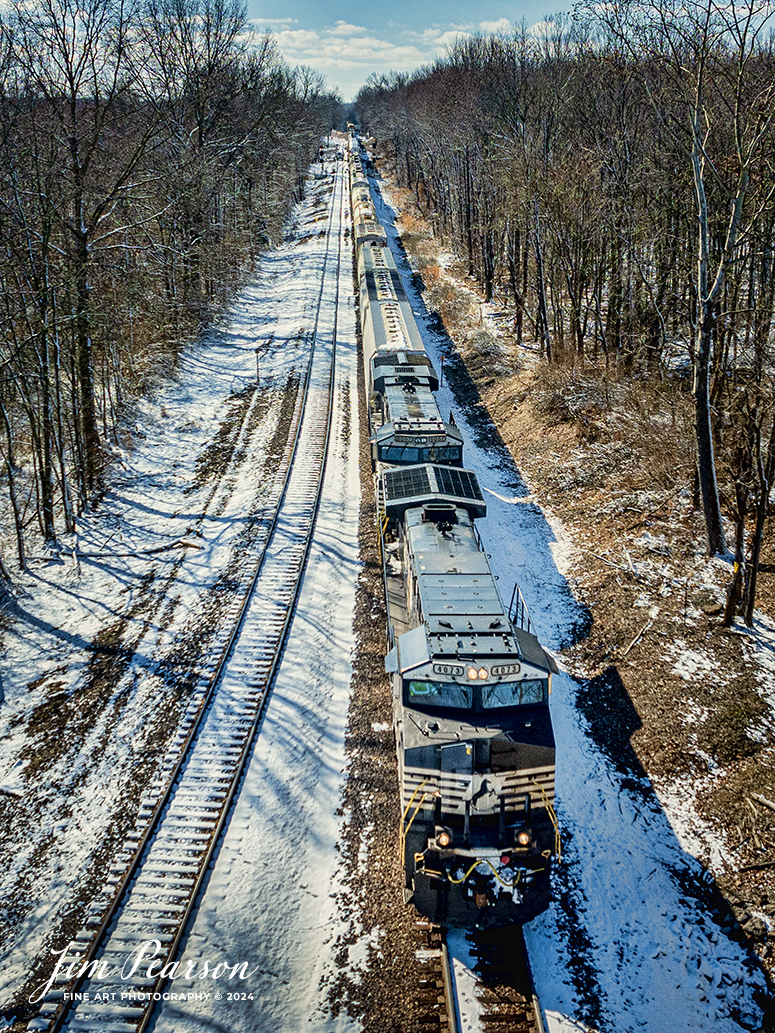 Norfolk Southern 4073 and 8057 lead NS 125 east at Hatfield Junction, as they head east on February 17th, 2024, on the NS Southern East District, just east of Oakland City, Indiana.

Tech Info: DJI Mavic 3 Classic Drone, RAW, 22mm, f/8, 1/4000, ISO 110.

#trainphotography #railroadphotography #trains #railways #jimpearsonphotography #trainphotographer #railroadphotographer #dronephoto #trainsfromadrone #IndianaTrains