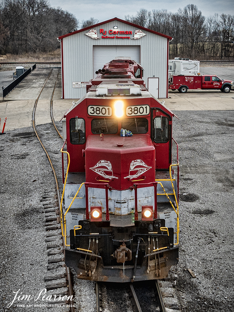RJ Corman engines set outside the engine house at Guthrie, Ky as their crew prepares to head out for their daily local run to the Clarksville, TN area on February 22nd, 2024, on the RJC Memphis Line. 

This train is referred to as the Cumberland City turn and departs from Guthrie, Ky weekdays, usually in the morning, runs the Memphis Line to Cumberland City, TN and then returns after working industries like this one along the way.

The Memphis Line currently covers just over 113 track miles between Bowling Green, Ky and Cumberland City, TN, servicing 47 customers along the line. It interchanges with CSX on average six days a week at Bowling Green and Guthrie, Ky. The yard office for this line is located at Guthrie.

Tech Info: DJI Mavic 3 Classic Drone, RAW, 22mm, f/2.8, 1/200, ISO 110.

#trainphotography #railroadphotography #trains #railways #jimpearsonphotography #trainphotographer #railroadphotographer #csxt #dronephoto #trainsfromadrone #paducahandlouisvillerailroad #trending