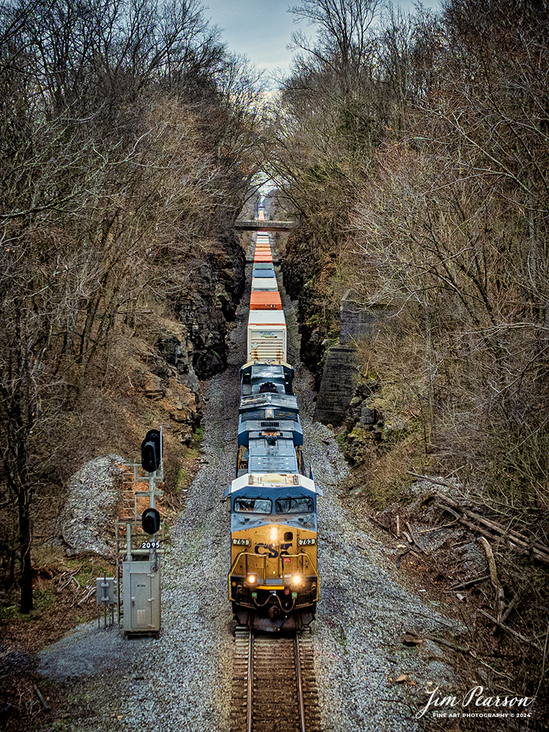 CSXT 763 leads intermodal I128 as it emerges from the Red River Cut at Adams, Tennessee as it heads north on the CSX Henderson Subdivision on February 27th, 2024. The overpass in the distance is hwy 41, a great spot to photograph trains from. Yesterday’s photo was shot from the bridge with my drone.

Tech Info: DJI Mavic 3 Classic Drone, RAW, 22mm, f/2.8, 1/400, ISO 170.

#trainphotography #railroadphotography #trains #railways #jimpearsonphotography #trainphotographer #railroadphotographer #csxt #dronephoto #trainsfromadrone #trending