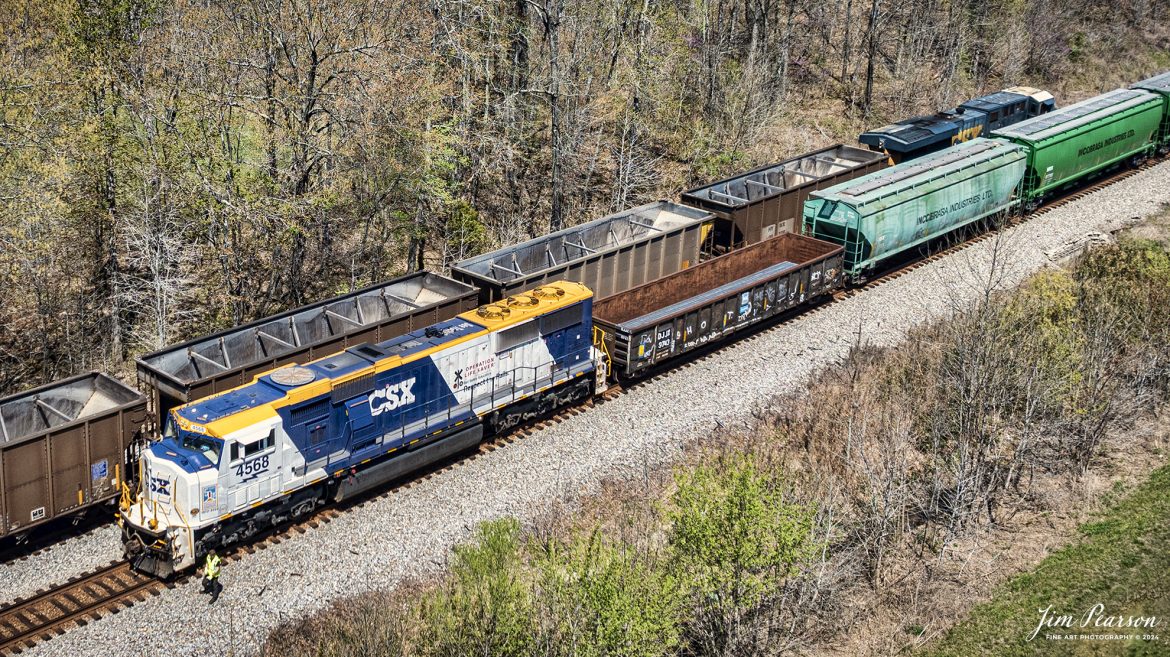 The conductor on CSX X513 does a roll-by inspection on a northbound empty coal train at Romney, Nortonville, Ky, with the CSX Operation Lifesaver locomotive CSXT 4568 leading, on the Henderson Subdivision on April 12th, 2023.

According to a CSX press release: CSX unveiled a new OLI rail safety commemorative locomotive in September of 2022, and it was painted at the railroads locomotive shop in Huntington, West Virginia. The CSXT 4568 engine will travel the company’s rail network as a visual reminder for the public to be safe at highway-rail grade crossings and near railroad tracks.

Tech Info: DJI Mavic 3 Classic Drone, RAW, 22mm, f/8, 1/1600, ISO 100.

#trainphotography #railroadphotography #trains #railways #jimpearsonphotography #trainphotographer #railroadphotographer #dronephoto #trainsfromadrone #CSX #trending