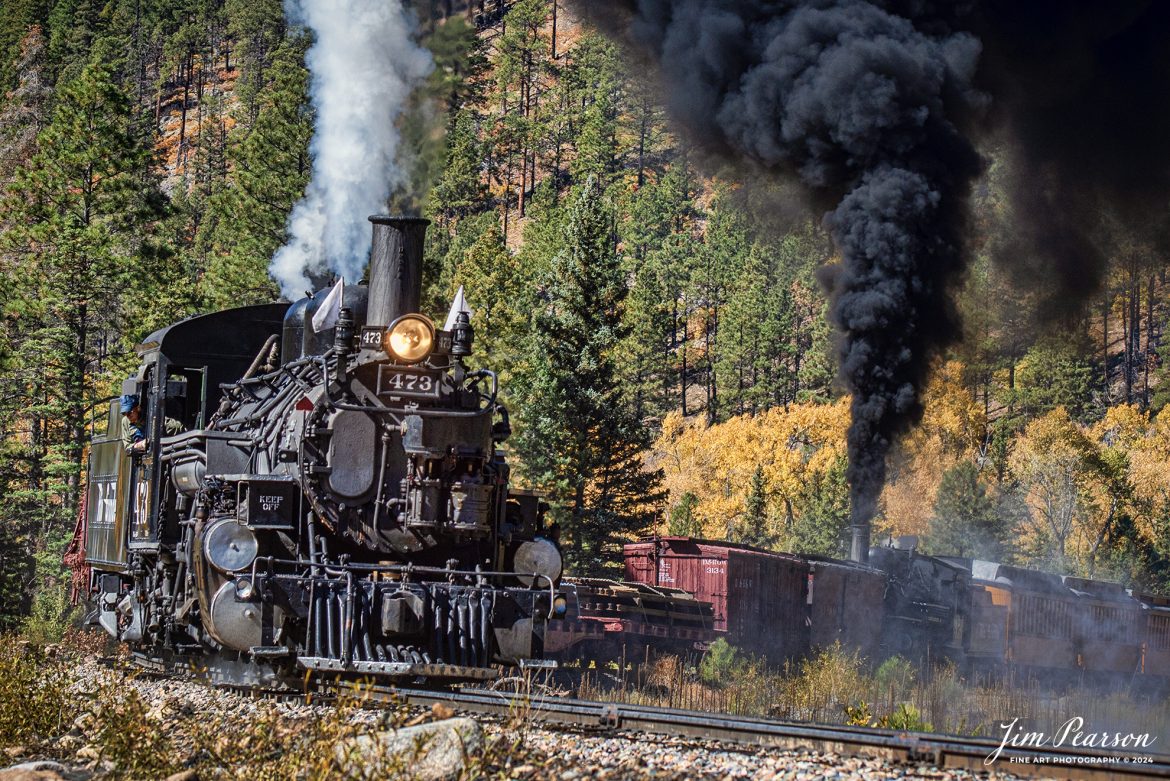 Durango and Silverton Narrow Gauge steam locomotive D&RGW 473 leads a K-28 100th Anniversary Special as they head through the curve at Goblin Fire, Milepost 480.5, between Durango and Silverton, Colorado, on October 16th, 2023, with mid-train helper D&RGW 476.

According to Wikipedia: The Durango and Silverton Narrow Gauge Railroad, often abbreviated as the D&SNG, is a 3 ft (914 mm) narrow-gauge heritage railroad that operates on 45.2 mi (72.7 km) of track between Durango and Silverton, in the U.S. state of Colorado. The railway is a federally designated National Historic Landmark and was also designated by the American Society of Civil Engineers as a National Historic Civil Engineering Landmark in 1968.

Tech Info: Nikon D810, RAW, Nikon 70-300 @ 90mm, f/5.6, 1/800, ISO 110

#railroad #railroads #train, #trains #bestphoto #soldphoto #railway #railway #soldtrainphotos #steamtrains #railtransport #railroadengines #picturesoftrains #picturesofrailways #besttrainphotograph #bestphoto #photographyoftrains #steamtrainphotography #soldpicture #bestsoldpicture #JimPearsonPhotography #DurangoandSilvertonRailroad