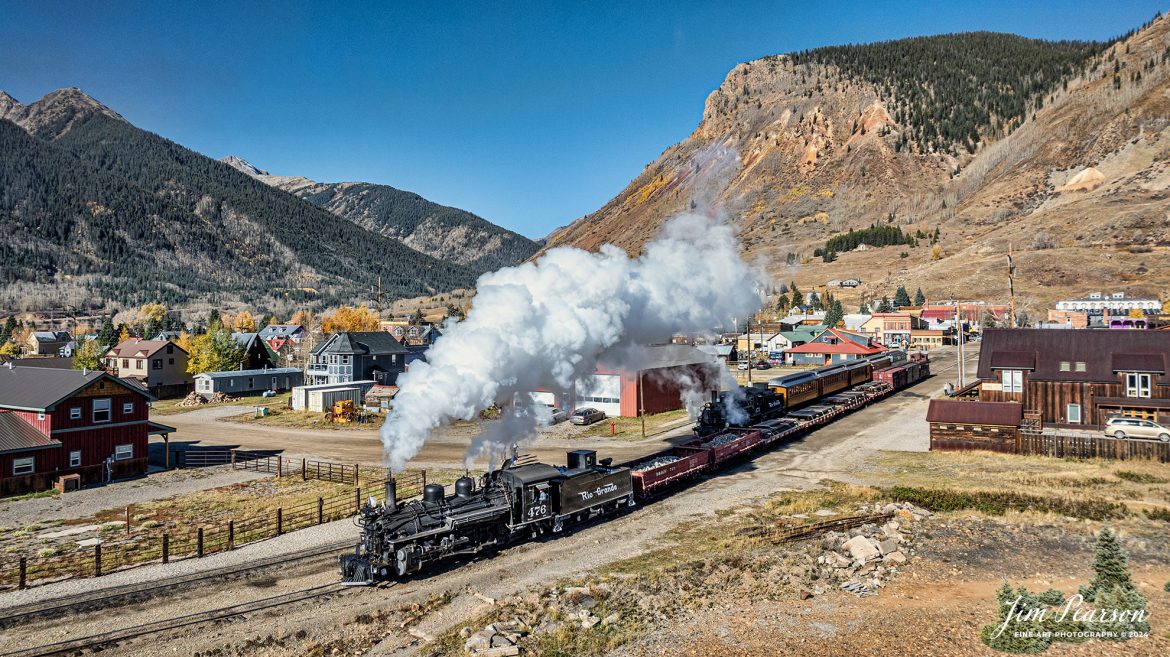 Durango and Silverton Narrow Gauge steam locomotive D&RGW 476 pulls out of Silverton, Colorado on the early morning of October 17th, 2023, as D&RGW 476 waits to follow it. They were running on the line as a K-28 100th Anniversary Special between Silverton and Durango, Colorado for another day of running a photo charter special.

According to Wikipedia: The Durango and Silverton Narrow Gauge Railroad, often abbreviated as the D&SNG, is a 3 ft (914 mm) narrow-gauge heritage railroad that operates on 45.2 mi (72.7 km) of track between Durango and Silverton, in the U.S. state of Colorado. The railway is a federally designated National Historic Landmark and was also designated by the American Society of Civil Engineers as a National Historic Civil Engineering Landmark in 1968.

Tech Info: DJI Mavic 3 Classic Drone, RAW, 22mm, f/2.8, 1/2000, ISO 110.

#railroad #railroads #train, #trains #bestphoto #soldphoto #railway #railway #soldtrainphotos #steamtrains #railtransport #railroadengines #picturesoftrains #picturesofrailways #besttrainphotograph #bestphoto #photographyoftrains #steamtrainphotography #soldpicture #bestsoldpicture #JimPearsonPhotography #DurangoandSilvertonRailroad