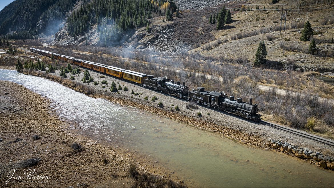 On October 18th, 2023, double-header steam locomotives, Denver and Rio Grande Western 473 and 493 pull one of the daily passenger along the Animas River as they head into Silverton, Colorado.

According to Wikipedia: The Durango and Silverton Narrow Gauge Railroad, often abbreviated as the D&SNG, is a 3 ft (914 mm) narrow-gauge heritage railroad that operates on 45.2 mi (72.7 km) of track between Durango and Silverton, in the U.S. state of Colorado. The railway is a federally designated National Historic Landmark and was also designated by the American Society of Civil Engineers as a National Historic Civil Engineering Landmark in 1968.

Tech Info: DJI Mavic 3 Classic Drone, RAW, 22mm, f/2.8, 1/1600, ISO 150.

#railroad #railroads #train #trains #bestphoto #railroadengines #picturesoftrains #picturesofrailway #bestphotograph #photographyoftrains #trainphotography #JimPearsonPhotography #DurangoandSilvertonRailroad #trending