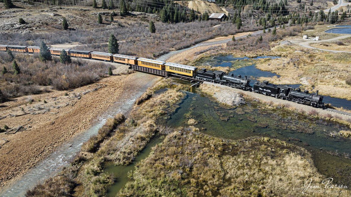 On October 18th, 2023, double-header steam locomotives, Denver and Rio Grande Western 473 and 493 pull one of the daily passenger trains across Mineral Creek as they head into Silverton, Colorado.

According to Wikipedia: The Durango and Silverton Narrow Gauge Railroad, often abbreviated as the D&SNG, is a 3 ft (914 mm) narrow-gauge heritage railroad that operates on 45.2 mi (72.7 km) of track between Durango and Silverton, in the U.S. state of Colorado. The railway is a federally designated National Historic Landmark and was also designated by the American Society of Civil Engineers as a National Historic Civil Engineering Landmark in 1968.

Tech Info: DJI Mavic 3 Classic Drone, RAW, 22mm, f/2.8, 1/640, ISO 100.

#railroad #railroads #train #trains #bestphoto #railroadengines #picturesoftrains #picturesofrailway #bestphotograph #photographyoftrains #trainphotography #JimPearsonPhotography #DurangoandSilvertonRailroad #trending