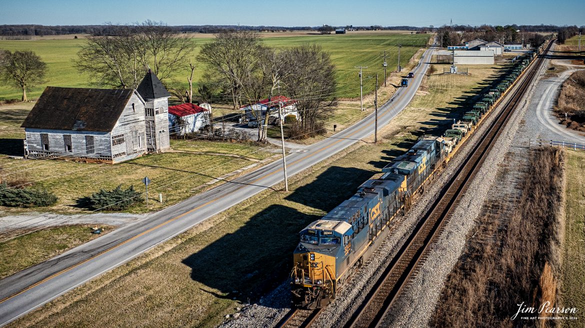 Northbound CSX 3244 leads loaded military train S279 as they sit at the north end of the siding at Trenton, Kentucky, on October 5th, 2024, on the Henderson Subdivision, as they wait to meet a southbound grain train. They will head north shortly to deliver their military loads to the Ft. Campbell lead at Hopkinsville, Ky.

Tech Info: DJI Mavic 3 Classic Drone, RAW, 22mm, f/2.8, 1/2000, ISO 110.

#trainphotography #railroadphotography #trains #railways #jimpearsonphotography #trainphotographer #railroadphotographer #dronephoto #trainsfromadrone #CSX #trending
