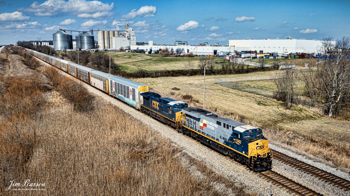 The CSX Seaboard System Heritage unit 1982 leads hot intermodal, CSX I025, as they as they head south on the Henderson Subdivision on March 4th, 2024, at Hopkinsville, Kentucky.

According to Wikipedia: The Seaboard System Railroad, Inc. (reporting mark SBD) was a US Class I railroad that operated from 1982 to 1986.

Since the late 1960s, Seaboard Coast Line Industries had operated the Seaboard Coast Line and its sister railroads, notably the Louisville & Nashville and Clinchfield, as the “Family Lines System”. In 1980, SCLI merged with the Chessie System to create the holding company CSX Corporation; two years later, CSX merged with the Family Lines railroads to create the Seaboard System Railroad.

In 1986, Seaboard renamed itself CSX Transportation, which absorbed the Chessie System’s two major railroads the following year.

Tech Info: DJI Mavic 3 Classic Drone, RAW, 22mm, f/2.8, 1/1600, ISO 100.

#trainphotography #railroadphotography #trains #railways #jimpearsonphotography #trainphotographer #railroadphotographer #csxt #dronephoto #trainsfromadrone #trending #CSXHeritageUnit