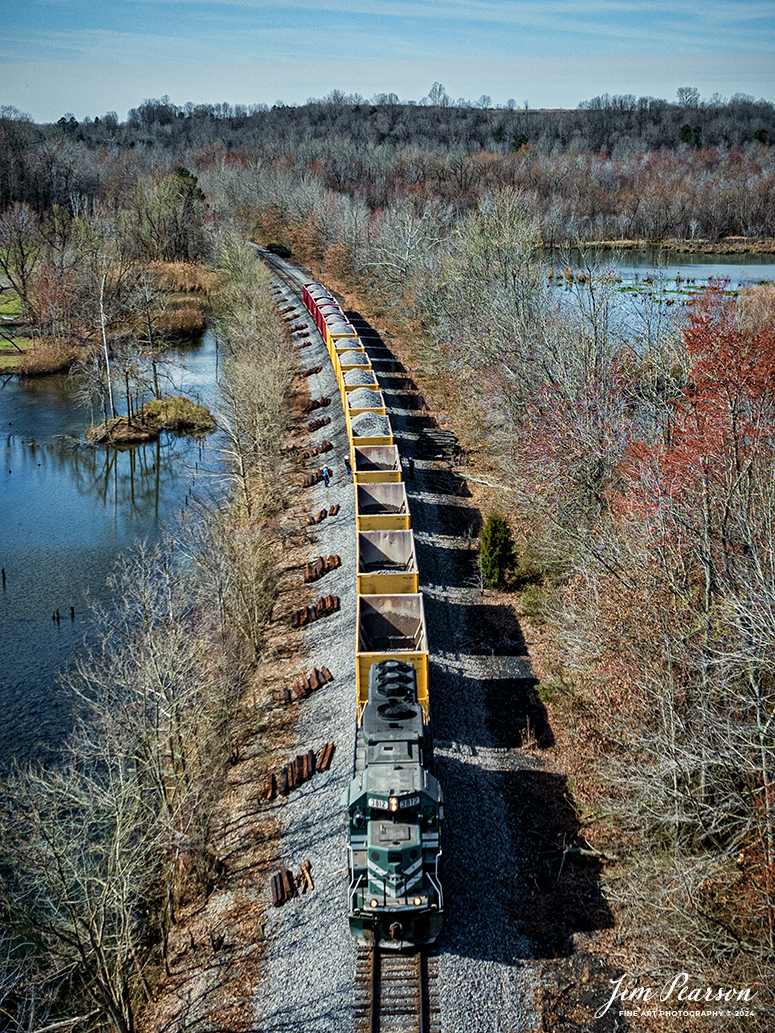 Paducah and Louisville Railway 3812 leads a loaded ballast train as they work on dropping ballast between Richland and Madisonville, Kentucky on March 12th, 2024, as spring starts to show in the surrounding area.

Tech Info: DJI Mavic 3 Classic Drone, RAW, 22mm, f/8, 1/2000, ISO 140.

#trainphotography #railroadphotography #trains #railways #jimpearsonphotography #trainphotographer #railroadphotographer #dronephoto #trainsfromadrone #PAL  #paducahandlouisvillerailway #trending