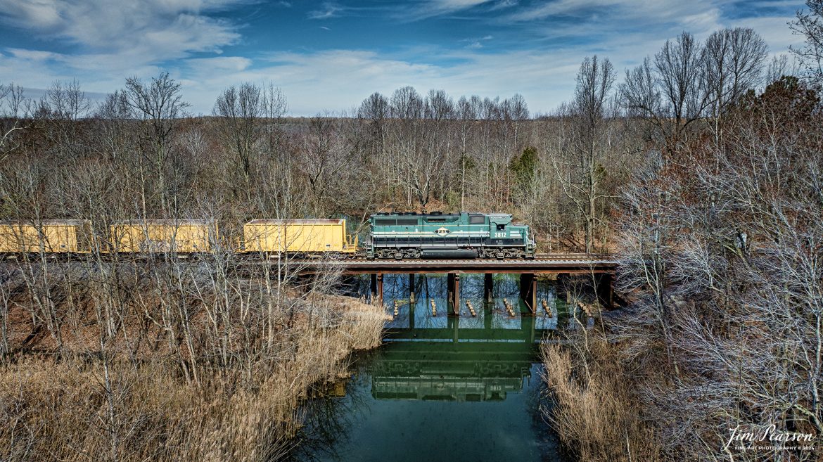Paducah and Louisville Railway 3812 leads a loaded ballast train as they cross over Clear Creek as they work on dropping ballast between Richland and Madisonville, Kentucky on March 12th, 2024.

Tech Info: DJI Mavic 3 Classic Drone, RAW, 22mm, f/8, 1/2000, ISO 140.

#trainphotography #railroadphotography #trains #railways #jimpearsonphotography #trainphotographer #railroadphotographer #dronephoto #trainsfromadrone #PAL  #paducahandlouisvillerailway #trending