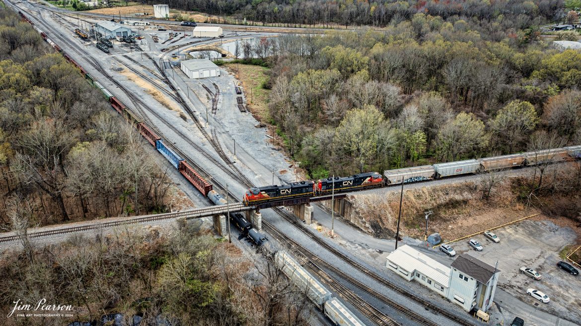The daily Canadian National (CN) local pulls across the fly-over at the Paducah and Louisville Railway yard in downtown Paducah Kentucky on March 15th, 2024, as they prepare to do their interchange work. On the right is the tower for the yard and in the upper left you can see the engine maintenance facility. 

Tech Info: DJI Mavic 3 Classic Drone, RAW, 22mm, f/2.8, 1/120, ISO 100.

#trainphotography #railroadphotography #trains #railways #jimpearsonphotography #trainphotographer #railroadphotographer #csxt #dronephoto #trainsfromadrone #trending #csxhendersonsubdivision #cnrailway #paducahandlouisvillerailway