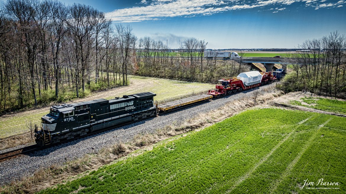 Norfolk Southern 3730 leads CSX S991 as they pass under I64 into St. James Curve, with an oversized Turbine load from Siemens Energy on a depressed flatbed, just south of Haubstadt, Indiana, on the CSX CE&D Subdivision, on March 20th, 2024, with a Fracht Caboose bringing up the rear. 

B229 originated at Birmingham, AL and is headed for New Castle, PA. I caught this move just north of Evansville, IN and gave chase to Patoka, Indiana. 

Tech Info: DJI Mavic 3 Classic Drone, RAW, 22mm, f/2.8, 1/3200, ISO 190.

#trainphotography #railroadphotography #trains #railways #jimpearsonphotography #trainphotographer #railroadphotographer #csxt #dronephoto #trainsfromadrone #trending #csxcedsubdivision #norfolksouthern #trending