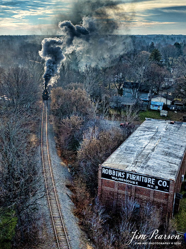 Pere Marquette 1225 heads out of Owosso, Michigan as it approaches the Robbins Furniture Company Warehouse Number 3, with the morning North Pole Express excursion train that runs between Owosso and to the Village of Ashley Country Christmas, on December 16th, 2023. 

According to their website, Pere Marquette 1225, the largest and most impressive piece in the Steam Railroading Institute’s collection, is one of the largest operating steam locomotives in Michigan. The 1225 was built in October of 1941 by the Lima Locomotive Works in Lima, Ohio for the Pere Marquette Railway. It’s part of the National Register of Historic Structures and is renowned for its role in the 2004 Warner Brothers Christmas Classic, THE POLAR EXPRESS™. 1225’s blueprints were used as the prototype for the locomotive image as well as its sounds to bring the train in the animated film to life!

Tech Info: DJI Mavic 3 Classic Drone, RAW, 22mm, f/2.8, 1/2500, ISO 400.

railroad, railroads train, trains, best photo. sold photo, railway, railway, sold train photos, sold train pictures, steam trains, rail transport, railroad engines, pictures of trains, pictures of railways, best train photograph, best photo, photography of trains, steam, train photography, sold picture, best sold picture, Jim Pearson Photography, Pere Marquette 1225, Steam Railroading Institute