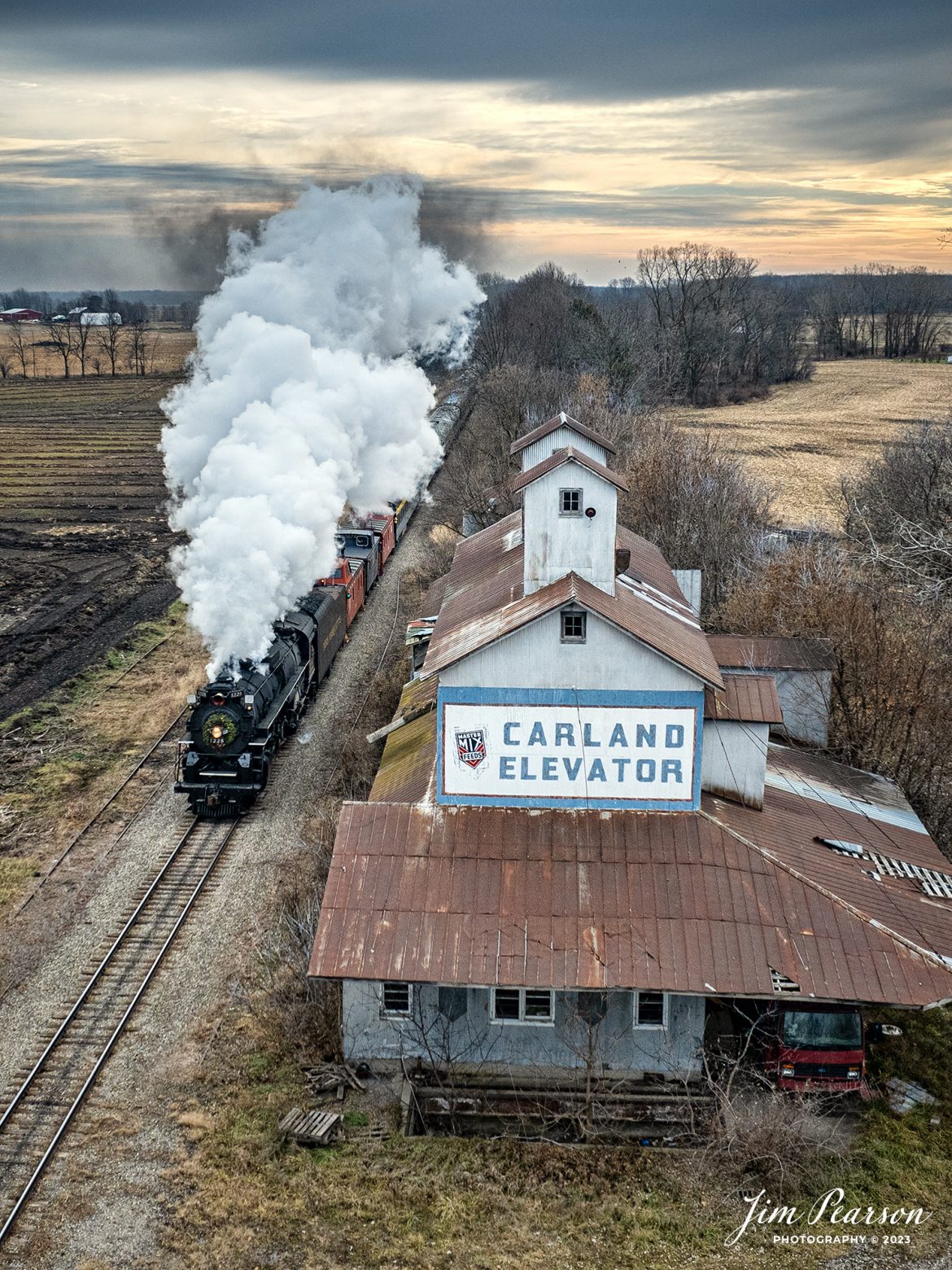 Steam Railroading Institute’s Pere Marquette 1225 passes the Carland Elevator at Carland, Michigan, as they run one of their last North Pole Express passenger train between Owosso and to the Village of Ashley, Michigan, for their Ashley Country Christmas, on December 16th, 2023. 

According to their website, Pere Marquette 1225, the largest and most impressive piece in the Steam Railroading Institute’s collection, is one of the largest operating steam locomotives in Michigan. The 1225 was built in October of 1941 by the Lima Locomotive Works in Lima, Ohio for the Pere Marquette Railway. It’s part of the National Register of Historic Structures and is renowned for its role in the 2004 Warner Brothers Christmas Classic, THE POLAR EXPRESS™. 1225’s blueprints were used as the prototype for the locomotive image as well as its sounds to bring the train in the animated film to life!

Tech Info: DJI Mavic 3 Classic Drone, RAW, 22mm, f/2.8, 1/1250, ISO 260.

#railroad #railroads #train #trains #bestphoto #railroadengines #picturesoftrains #picturesofrailway #bestphotograph #photographyoftrains #trainphotography #JimPearsonPhotography #steamtrains #trending