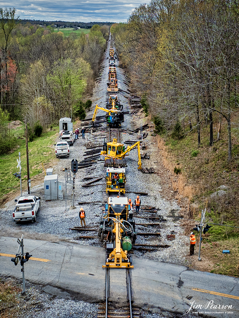 A Paducah and Louisville Railway track maintenance team works on replacing ties as they approach the highway 1337 crossing at Richland, Kentucky, on April 4th, 2024. The team has been making their way north from Dawson Springs for about a week or so and have just now reached the Defect Detector at MP 153.3 on the line, which is right next to my house here in Richland, so I didn’t have to go far to catch this shot! 

According to Wikipedia: The Paducah & Louisville Railway (reporting mark PAL) is a Class II railroad that operates freight service between Paducah and Louisville, Kentucky. The line is located entirely within the Commonwealth of Kentucky. The 270-mile (430 km) line was purchased from Illinois Central Gulf Railroad in August 1986.

Tech Info: DJI Mavic 3 Classic Drone, RAW, 22mm, f/2.8, 1/1000, ISO 140.

#trainphotography #railroadphotography #trains #railways #jimpearsonphotography #trainphotographer #railroadphotographer #csxt #dronephoto #trainsfromadrone #trending #csxhendersonsubdivision #palrailway #paducahandlouisvillerailway #trainsfromadrone
