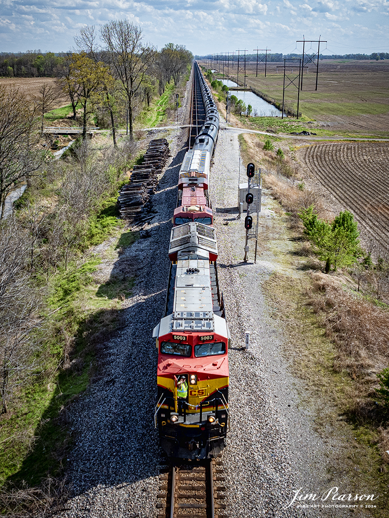 The conductor on the nose of KCS 5003 gives a friendly wave as empty ethanol train B622 pulls out of the siding at the north end of Rankin, Ky as they head north on April 8th, 2024, on the CSX Henderson Subdivision.

Tech Info: DJI Mavic 3 Classic Drone, RAW, 22mm, f/2.8, 1/2000, ISO 140.