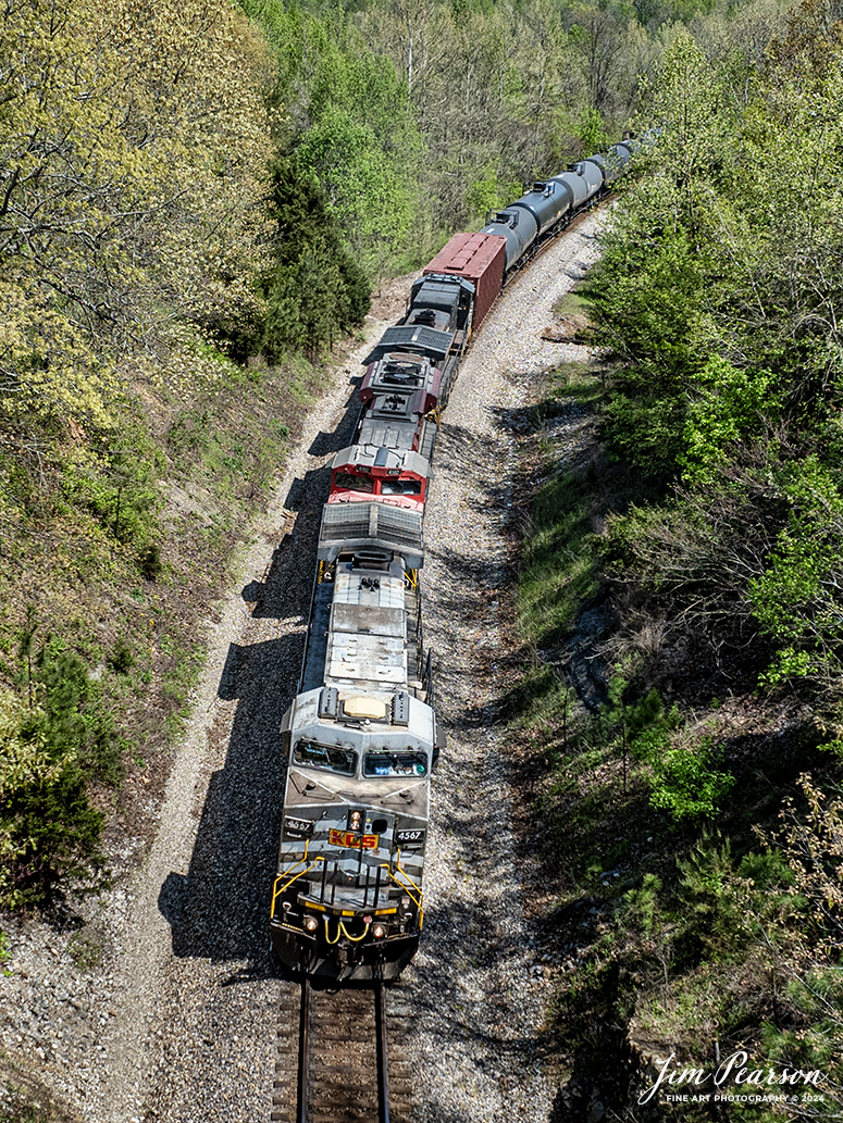 A loaded southbound ethanol train, CSX B647 with Kansas City Southern Gray Ghost 4567, KCS 4162 and Norfolk Southern 9649 leading, heads south through the Crofton Cut at Crofton, Kentucky on April 15th, 2024, on the CSX Henderson Subdivision.

The Henderson Subdivision sees foreign power quite often and this train is one example of it. This train runs from Bensenville, IL (CPKC) to Lawrenceville, GA, as needed.

Tech Info: DJI Mavic 3 Classic Drone, RAW, 22mm, f/2.8, 1/1000, ISO 100.