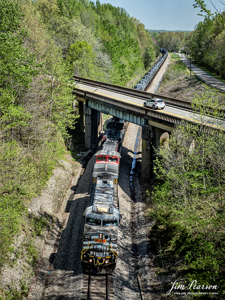 A loaded southbound ethanol train, CSX B647 with Kansas City Southern Gray Ghost 4567, KCS 4162 and Norfolk Southern 9649 leading, heads south as it passes under US 41 at Mortons Gap, Kentucky on April 15th, 2024, on the CSX Henderson Subdivision.

The Henderson Subdivision sees foreign power quite often and this train is one example of it. This train runs from Bensenville, IL (CPKC) to Lawrenceville, GA, as needed.

Tech Info: DJI Mavic 3 Classic Drone, RAW, 22mm, f/2.8, 1/1000, ISO 100.