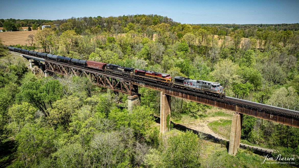 A loaded southbound ethanol train, CSX B647 with Kansas City Southern Gray Ghost 4567, KCS 4162 and Norfolk Southern 9649 leading, heads south across Red River Trestle at Adams, Tennessee, on April 15th, 2024, on the CSX Henderson Subdivision.

The Henderson Subdivision sees foreign power quite often and this train is one example of it. This train runs from Bensenville, IL (CPKC) to Lawrenceville, GA, as needed.

Tech Info: DJI Mavic 3 Classic Drone, RAW, 22mm, f/2.8, 1/1600, ISO 100.