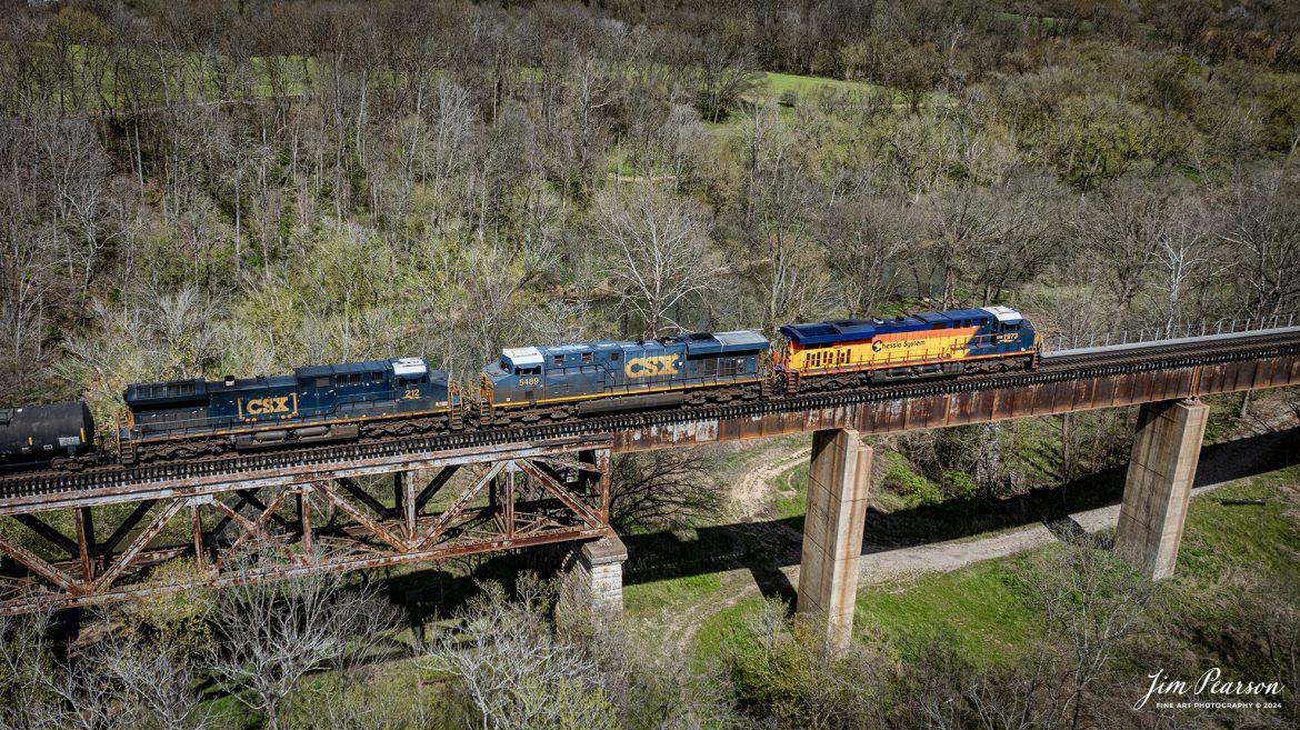 CSXT 1973, Chessie System Heritage Unit, leads CSX M647 as it passes over the Red River Trestle just north of Adams, TN as it continues south on the CSX Henderson Subdivision, on March 30th, 2024. The Henderson Subdivision has seen a lot of CSX Heritage units the last week or so and hopefully there’ll be more in the future so I can capture and share them with you! I’ll be posting some videos of these moves in future Saturday Edited Videos so keep an eye out for them!

According to Wikipedia: The three railroads that would make up the Chessie System had been closely related since the 1960s. C&O had acquired controlling interest in B&O in 1962, and the two had jointly controlled WM since 1967.

Chessie System, Inc. was a holding company that owned the Chesapeake and Ohio Railway (C&O), the Baltimore and Ohio Railroad (B&O), the Western Maryland Railway (WM), and Baltimore and Ohio Chicago Terminal Railroad (B&OCT). Trains operated under the Chessie name from 1973 to 1987.

On November 1, 1980, Chessie System merged with Seaboard Coastline Industries to form CSX Corporation. Initially, the three Chessie System railroads continued to operate separately, even after Seaboard’s six Family Lines System railroads were merged into the Seaboard System Railroad on December 29, 1982. That began to change in 1983, when the WM was merged into the B&O. The Chessie image continued to be applied to new and re-painted equipment until July 1, 1986, when CSXT introduced its own paint scheme. In April 1987, the B&O was merged into the C&O. In August 1987, C&O merged into CSX Transportation, a 1986 renaming of the Seaboard System Railroad, and the Chessie System name was retired.

Tech Info: DJI Mavic 3 Classic Drone, RAW, 22mm, f/2.8, 1/2000, ISO 100.

#trainphotography #railroadphotography #trains #railways #jimpearsonphotography #trainphotographer #railroadphotographer #csxt #dronephoto #trainsfromadrone #csx #csxheritageunit #trending