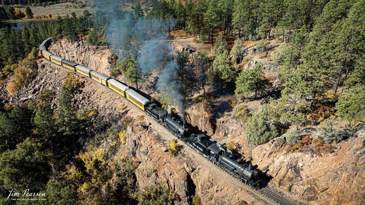 Denver and Rio Grande Western steam locomotives 473 and 493 head up a daily passenger train as they pull past Granite Point, just outside of Rockwood, Colorado, as they head to Silverton, CO, on October 15th, 2023.

According to Wikipedia: The Durango and Silverton Narrow Gauge Railroad, often abbreviated as the D&SNG, is a 3 ft (914 mm) narrow-gauge heritage railroad that operates on 45.2 mi (72.7 km) of track between Durango and Silverton, in the U.S. state of Colorado. The railway is a federally designated National Historic Landmark and was also designated by the American Society of Civil Engineers as a National Historic Civil Engineering Landmark in 1968.

Tech Info: DJI Mavic 3 Classic Drone, RAW, 22mm, f/2.8, 1/800, ISO 100.

#railroad #railroads #train #trains #bestphoto #railroadengines #picturesoftrains #picturesofrailway #bestphotograph #photographyoftrains #trainphotography #JimPearsonPhotography #DurangoandSilvertonRailroad #trending