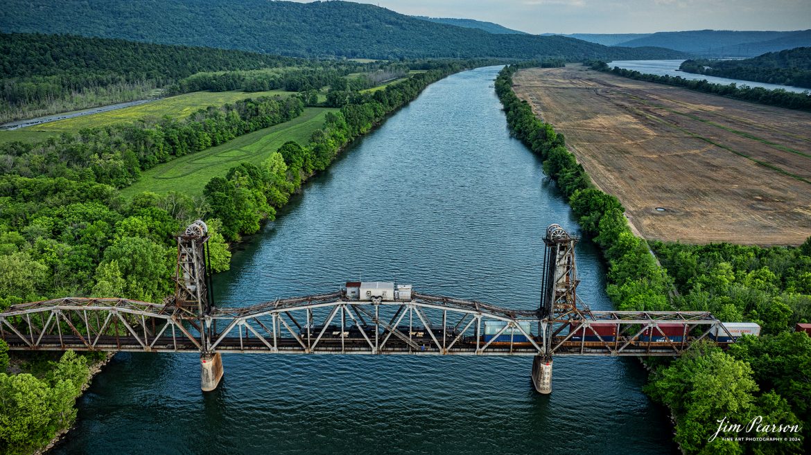 Norfolk Southern intermodal train crosses lift bridge over the Tennessee River on the CSX Chattanooga Subdivision, at Bridgeport, Alabama, as they make their way to the NS CNO&TP (Rathole) Second District and on north on April 26, 2024.

Tech Info: DJI Mavic 3 Classic Drone, RAW, 24mm, f/2.8, 1/500, ISO 150.