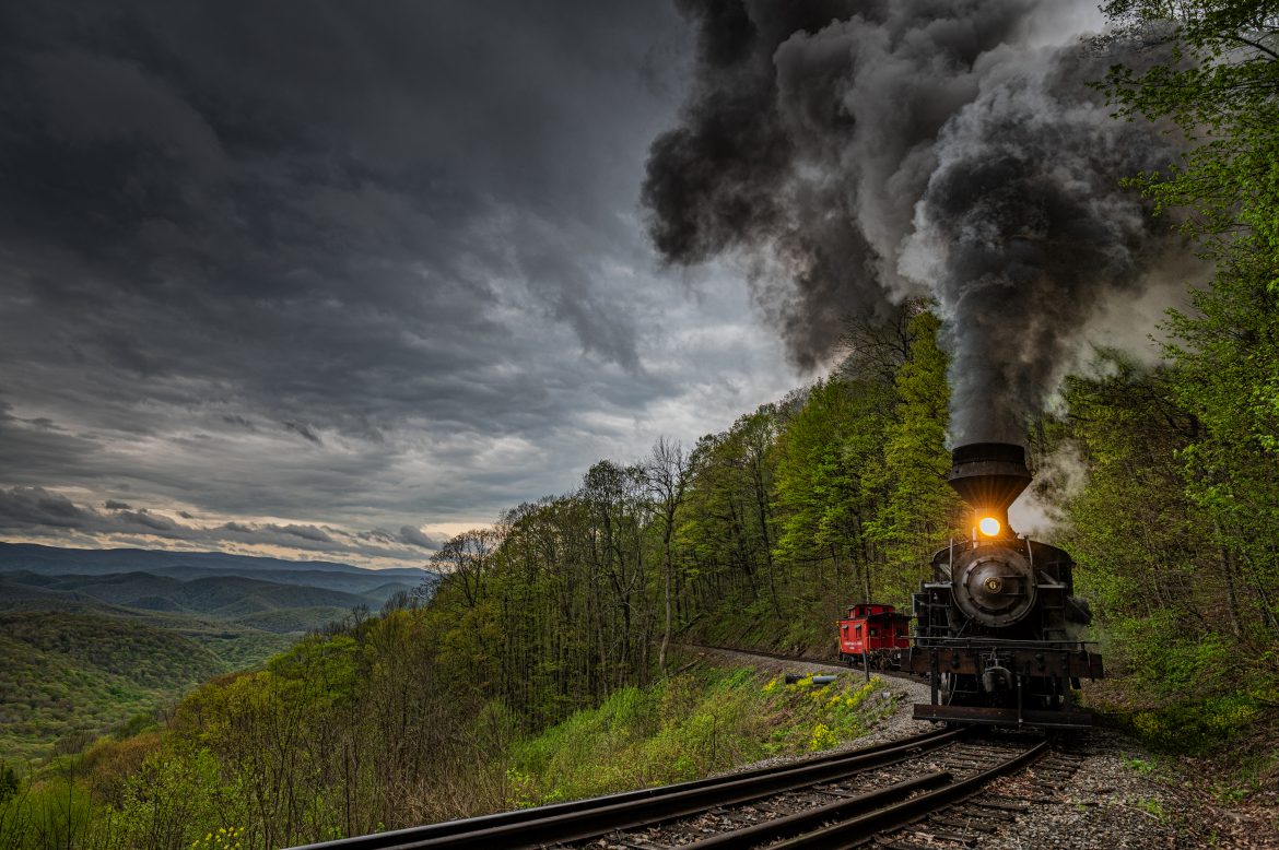 Cass Scenic Railway Heisler #6 pulls through the curve under stormy skies at the overlook at milepost 6 during the Cass Spring Photographers Special, out of Cass, West Virginia on May 3rd, 2025. This is the first of many of you have to look forward to from my trip to West Virginia. 

According to the Mountain Rail West Virginia Website: The Meadow River Lumber No. 6 was built by the Heisler Locomotive Works in Erie, PA, in 1929 for the Bostonia Coal & Clay Products Company of New Bethlehem, PA.

The Heisler was sold to the Meadow River Lumber Company at Rainelle, WV in 1939, where it was rostered as No. 6. She retired from the lumber company in 1965 and purchased by the State of West Virginia. The engine ran under its own steam from Rainelle to its new home in Cass in December 1966. No. 6 would begin operating on the railroad in 1968. The Heisler is the fastest geared locomotive in the Cass collection.

Tech Info: DJI Mavic 3 Classic Drone, RAW, 24mm, f/6.3, 1/640, ISO 900.

#railroad #railroads #train, #trains #railway #railway #steamtrains #railtransport #railroadengines #picturesoftrains #picturesofrailways #besttrainphotograph #bestphoto #photographyoftrains #bestsoldpicture #JimPearsonPhotography #trainsfromtheair #trainsfromadrone #cassscenicrailway