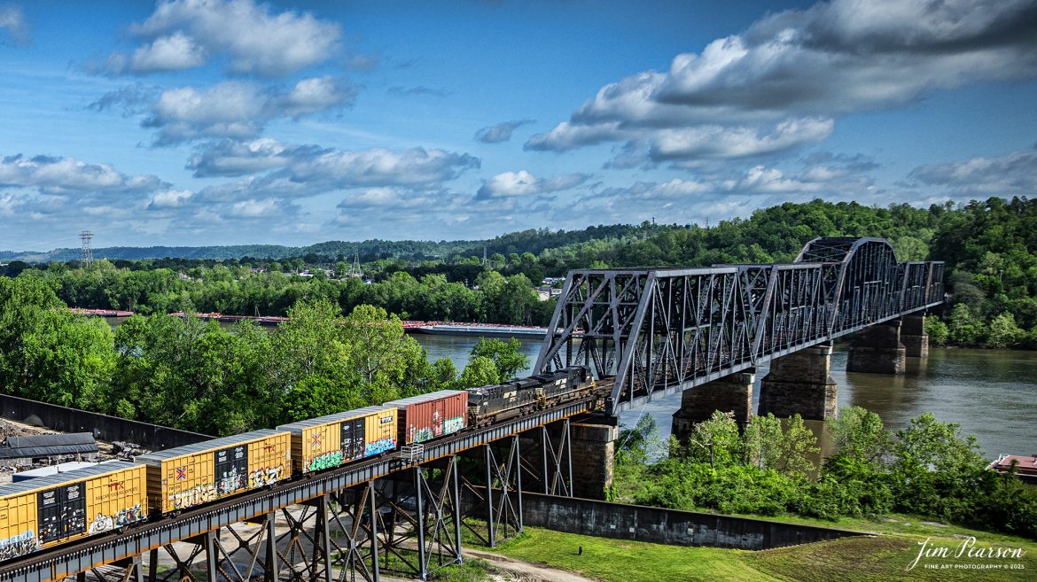 A Norfolk Southern mixed freight heads over the old N&W Bridge over the Ohio River on the Kenova District as it heads westbound at Kenova, on May 2nd, 2025.

According to Wikipedia, the bridge was first completed in 1892 with a single track, but its piers were sized for future widening. The expansion to two tracks was undertaken in 1913 by Norfolk and Western, the predecessor railway of the current owner, Norfolk Southern. The railroad added new trusses around the existing structure and expanded the piers. Rail traffic continued throughout construction, and the new tracks opened on June 9, 1913.

Tech Info: DJI Mavic 3 Classic Drone, RAW, 24mm, f/2.8, 1/2000, ISO 100.

#railroad #railroads #train, #trains #railway #railway #railtransport #railroadengines #picturesoftrains #picturesofrailways #besttrainphotograph #bestphoto #photographyoftrains #bestsoldpicture #JimPearsonPhotography #trainsfromtheair #trainsfromadrone #norfolksouthern