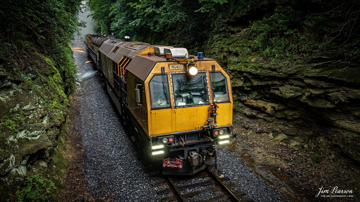 LORAM Railgrinder 403 passes through the cut at Charleston, Kentucky, as it works their way south on the Paducah and Louisville Railway, on June 5th, 2025.

According to Wikipedia: A rail grinder (or rail grinder) is a maintenance of way vehicle or train used to restore the profile and remove irregularities from worn tracks to extend its life and to improve the ride of trains using the track.

Tech Info: DJI Mavic 3 Classic Drone, RAW, 24mm, f/2.8, 1/60, ISO 100.

#railroad #railroads #train, #trains #railway #railway #steamtrains #railtransport #railroadengines #picturesoftrains #picturesofrailways #besttrainphotograph #bestphoto #photographyoftrains #bestsoldpicture #JimPearsonPhotography #Brightline #passengertrains #trainsfromtheair #trainsfromadrone #loram