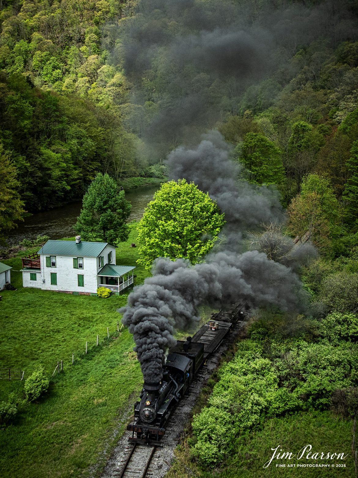 Cass Scenic Railroad Heisler #6 pulls through the countryside passing a small white house at milepost 92 on the way to Durban, West Virginia, during the Cass Spring Photographers Special, out of Cass, West Virginia on May 4th, 2025. 

According to the Mountain Rail West Virginia Website: The Meadow River Lumber No. 6 was built by the Heisler Locomotive Works in Erie, PA, in 1929 for the Bostonia Coal & Clay Products Company of New Bethlehem, PA.

The Heisler was sold to the Meadow River Lumber Company at Rainelle, WV in 1939, where it was rostered as No. 6. She retired from the lumber company in 1965 and was purchased by the purchased it by the state of West Virginia purchased. The engine ran under its own steam from Rainelle to its new home in Cass in December 1966. No. 6 would begin operating on the railroad in 1968. The Heisler is the fastest geared locomotive in the Cass collection.

Tech Info: DJI Mavic 3 Classic Drone, RAW, 24mm, f/2.8, 1/1000, ISO 100.

#railroad #railroads #train, #trains #railway #railway #steamtrains #railtransport #railroadengines #picturesoftrains #picturesofrailways #besttrainphotograph #bestphoto #photographyoftrains #bestsoldpicture #JimPearsonPhotography #trainsfromtheair #trainsfromadrone #steamtrain #casssenicrailway