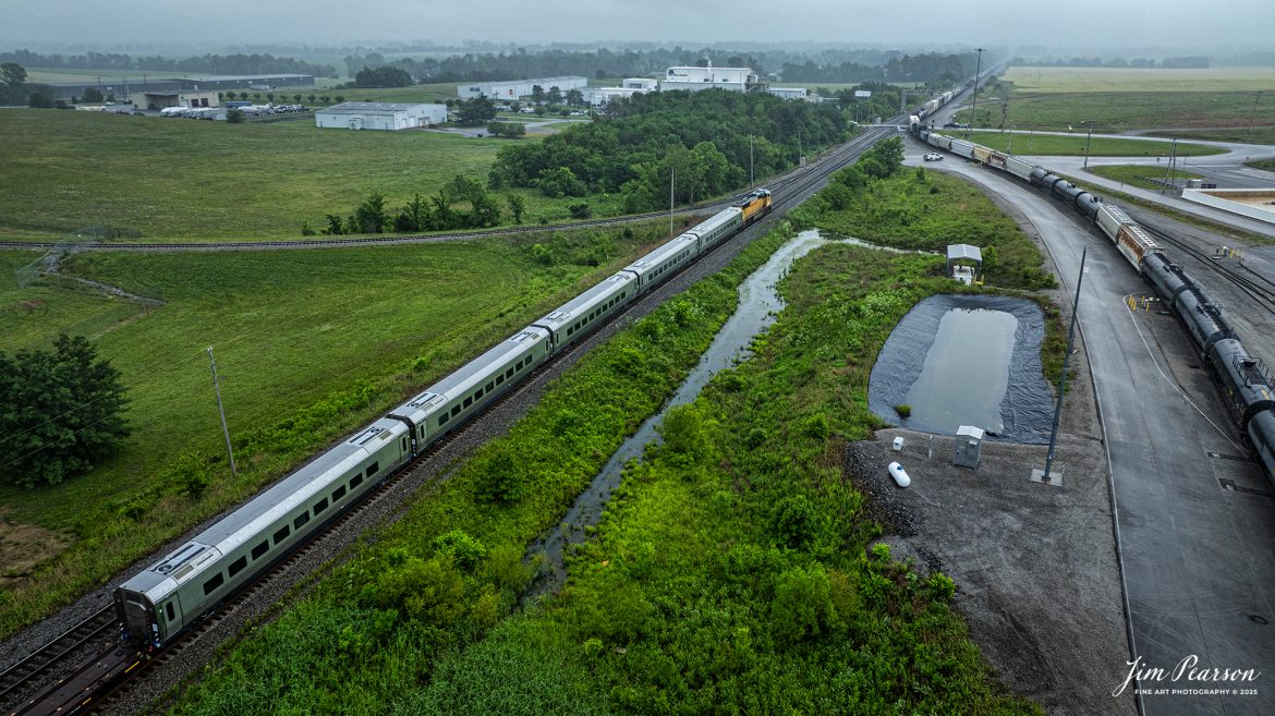 CSX S983, led by Union Pacific 4016, waits for  southbound M513 to clear just short of John Rivers Road crossing at Casky Yard in Hopkinsville, Ky, as it leads 5 new Brightline Cars bound for Florida on May 27th, 2025, on the CSX Henderson Subdivision.

Tech Info: DJI Mavic 3 Classic Drone, RAW, 24mm, f/2.8, 1/1000, ISO 100.

#railroad #railroads #train, #trains #railway #railway #steamtrains #railtransport #railroadengines #picturesoftrains #picturesofrailways #besttrainphotograph #bestphoto #photographyoftrains #bestsoldpicture #JimPearsonPhotography #Brightline #passengertrains #trainsfromtheair #trainsfromadrone
