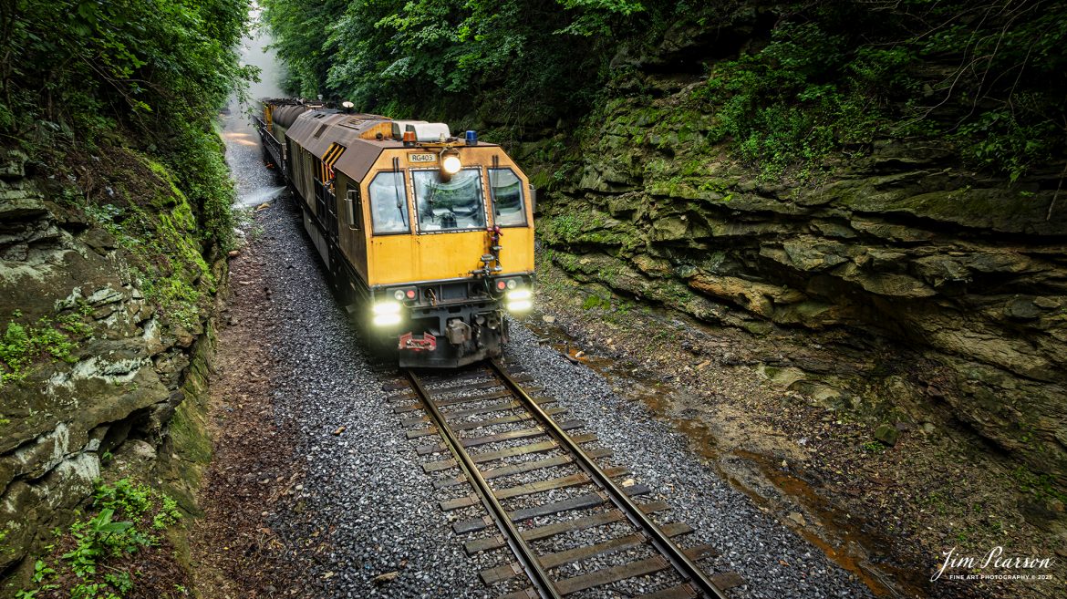 LORAM Railgrinder 403 passes through the cut at Charleston, Kentucky, as it works their way south on the Paducah and Louisville Railway, on June 5th, 2025.

According to Wikipedia: A rail grinder (or rail grinder) is a maintenance of way vehicle or train used to restore the profile and remove irregularities from worn tracks to extend its life and to improve the ride of trains using the track.

Tech Info: DJI Mavic 3 Classic Drone, RAW, 24mm, f/2.8, 1/60, ISO 100.

#railroad #railroads #train, #trains #railway #railway #steamtrains #railtransport #railroadengines #picturesoftrains #picturesofrailways #besttrainphotograph #bestphoto #photographyoftrains #bestsoldpicture #JimPearsonPhotography #Brightline #passengertrains #trainsfromtheair #trainsfromadrone #loram