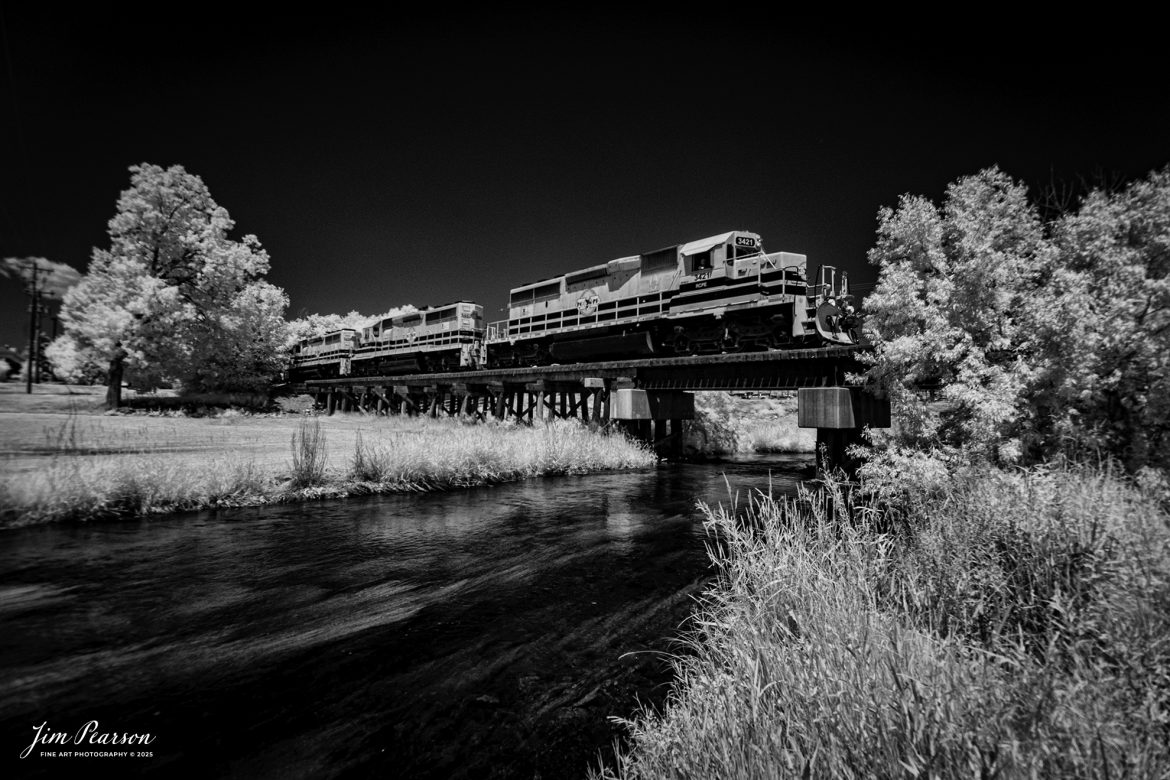In this week’s Saturday Infrared photo, we catch Rapid City, Pierre & Eastern Railroad (RCPE) 3421 as it leads their train eastbound into Rapid City, South Dakota on the Black Hills Subdivision.

According to Wikipedia, the Rapid City, Pierre & Eastern Railroad (reporting mark RCPE) is a Class II freight railroad operating across South Dakota and southern Minnesota in the northern plains of the United States. Portions of the railroad also extend into Wyoming and Nebraska. It is owned and operated by Genesee & Wyoming. The primary commodities shipped are grain, clay, and cement. Operations began on June 1, 2014.

Genesee & Wyoming, a holding company of mostly short line railroads, formed the Rapid City, Pierre & Eastern to acquire the western end of the former Dakota, Minnesota and Eastern Railroad (DM&E) rail line from the Canadian Pacific Railway (CPR). The RCPE and DM&E entered an agreement on January 2, 2014, wherein RCPE would acquire 670 miles of track and 219 miles of trackage rights from the DM&E. The acquisition was completed on May 30, 2014, for $210 million. Most of its employees came from the DM&E.

Tech Info: Fuji, RAW, Nikon 10-24 @ 11mm, f/4.5, 1/1000, ISO 400.

#railroad #railroads #train, #trains #railway #railway #railtransport #railroadengines #picturesoftrains #picturesofrailways #besttrainphotograph #bestphoto #photographyoftrains #bestsoldpicture #JimPearsonPhotography #rcpe #shortlinerailroad #irphotography