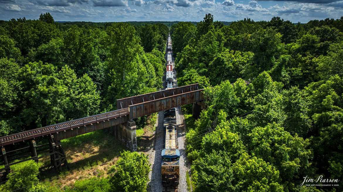 CSXT 309 leads B620, a northbound combined freight and Ethanol Empties train as it passes under the Paducah and Louisville Railway at the location known as Monarch at Madisonville, Kentucky, on the CSX Henderson Subdivision, on July 7th, 2025. 

Tech Info: DJI Mavic 3 Classic Drone, RAW, 22mm, f/2.8, 1/3200, ISO 100.

#railroad #railroads #train, #trains #railway #railway #steamtrains #railtransport #railroadengines #picturesoftrains #picturesofrailways #besttrainphotograph #bestphoto #photographyoftrains #bestsoldpicture #JimPearsonPhotography #trainsfromtheair #trainsfromadrone