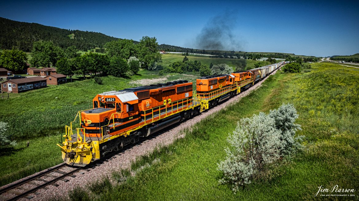 Rapid City, Pierre & Eastern Railroad (RCPE) 3421 as it leads their train eastbound through the countryside along I90, as they head for Rapid City, South Dakota on the Black Hills Subdivision, on June 26th, 2025.

According to Wikipedia, the Rapid City, Pierre & Eastern Railroad (reporting mark RCPE) is a Class II freight railroad operating across South Dakota and southern Minnesota in the northern plains of the United States. Portions of the railroad also extend into Wyoming and Nebraska. It is owned and operated by Genesee & Wyoming. The primary commodities shipped are grain, clay, and cement. Operations began on June 1, 2014.

Genesee & Wyoming, a holding company of mostly short line railroads, formed the Rapid City, Pierre & Eastern to acquire the western end of the former Dakota, Minnesota and Eastern Railroad (DM&E) rail line from the Canadian Pacific Railway (CPR). The RCPE and DM&E entered an agreement on January 2, 2014, wherein RCPE would acquire 670 miles of track and 219 miles of trackage rights from the DM&E. The acquisition was completed on May 30, 2014, for $210 million. Most of its employees came from the DM&E.

Tech Info: DJI Mavic 3 Classic Drone, RAW, 24mm, f/5, 1/3200, ISO 100.

#railroad #railroads #train, #trains #railway #railway #steamtrains #railtransport #railroadengines #picturesoftrains #picturesofrailways #besttrainphotograph #bestphoto #photographyoftrains #bestsoldpicture #JimPearsonPhotography #trainsfromtheair #trainsfromadrone #rcperailway #shortlinerailroads #southdakotarailroads